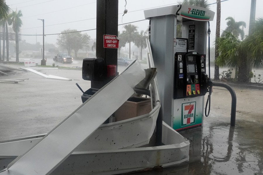 An apparent tornado caused by Hurricane Milton, tore the awning off a 7-Eleven convenient store, Wednesday, Oct. 9, 2024, in Cape Coral, Fla.(AP Photo/Marta Lavandier)