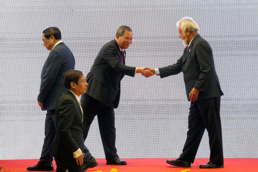 Chinese Premier Li Qiang, center, shakes hands with East Timor's Prime Minister Xanana Gusmao, right, as Vietnamese Prime Minister Pham Minh Chinh, left, and Myanmar's Foreign Ministry Permanent Secretary Aung Kyaw Moe, bottom, walk past by, during the 27th Association of Southeast Asian Nations (ASEAN)-China Summit in Vientiane, Laos, Thursday, Oct. 10, 2024. (AP Photo/Dita Alangkara)