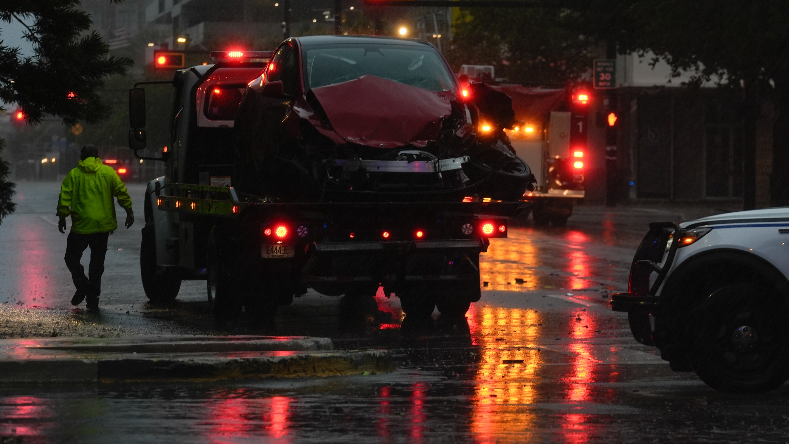 A tow truck responds following a traffic accident between a car and a fire truck returning from a call, on near-deserted streets in downtown Tampa, Fla., during the approach of Hurricane Milton, Wednesday, Oct. 9, 2024. (AP Photo/Rebecca Blackwell)