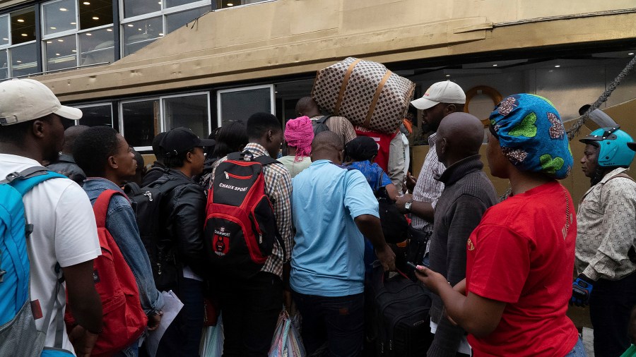 Passengers board the Emmanuel 2 ferry, linking Goma to Bukavu on lake Kivu, in Goma, Congo Tuesday, Oct. 8, 2024. (AP Photo/Justin Kabumba)