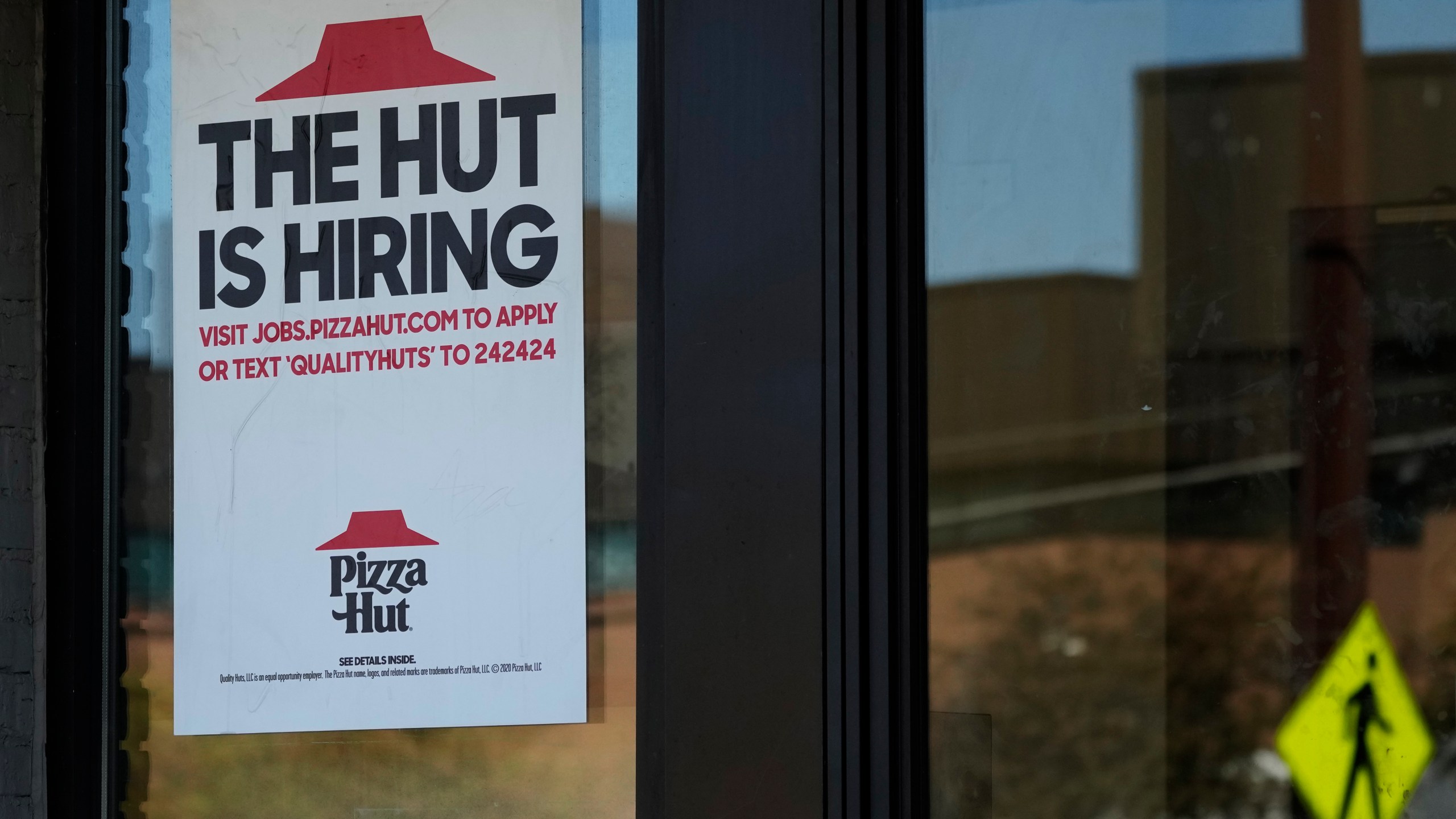 A hiring sign is displayed at a restaurant in Buffalo Grove, Ill., Tuesday, Oct. 8, 2024. (AP Photo/Nam Y. Huh)