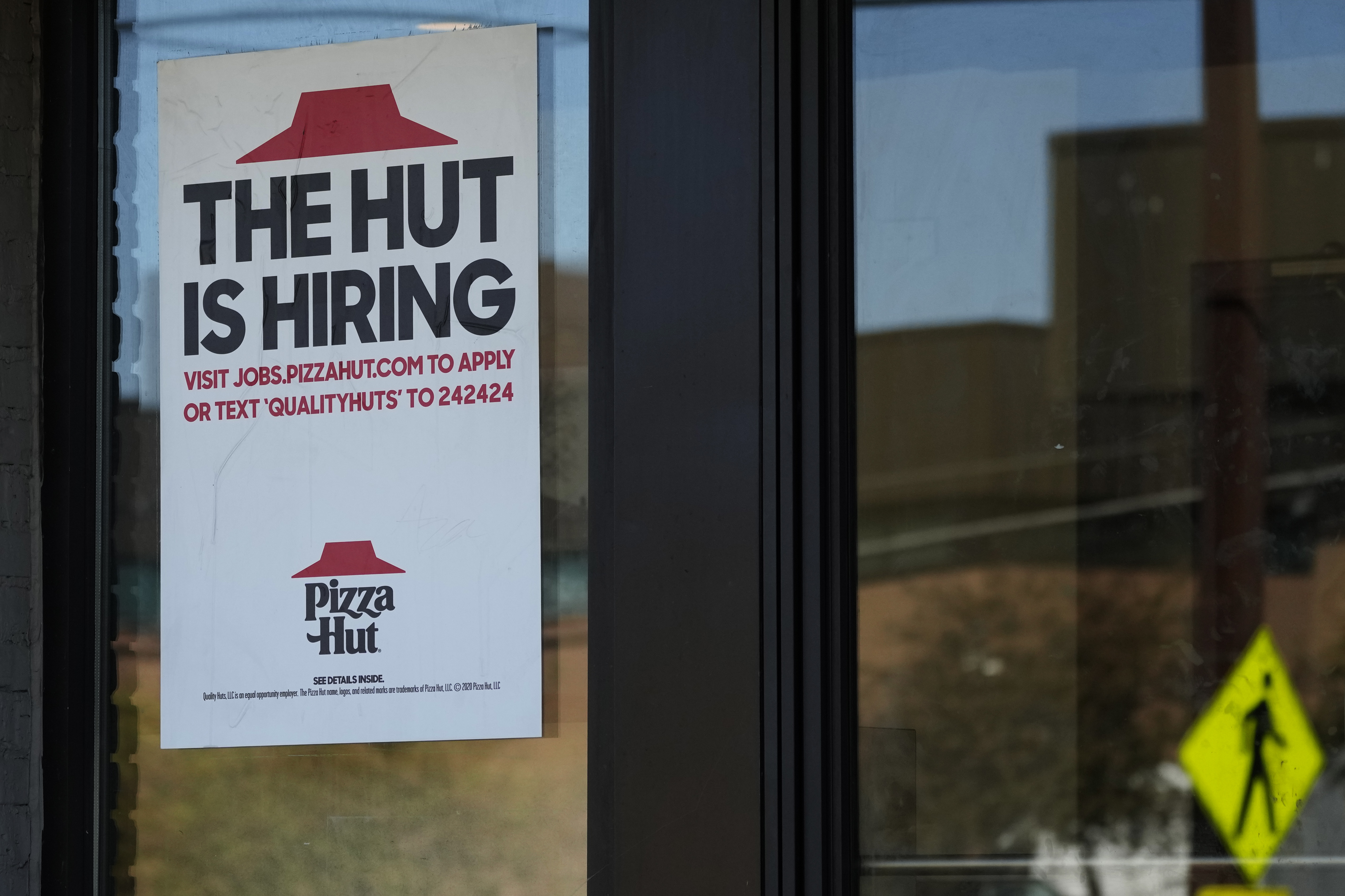 A hiring sign is displayed at a restaurant in Buffalo Grove, Ill., Tuesday, Oct. 8, 2024. (AP Photo/Nam Y. Huh)