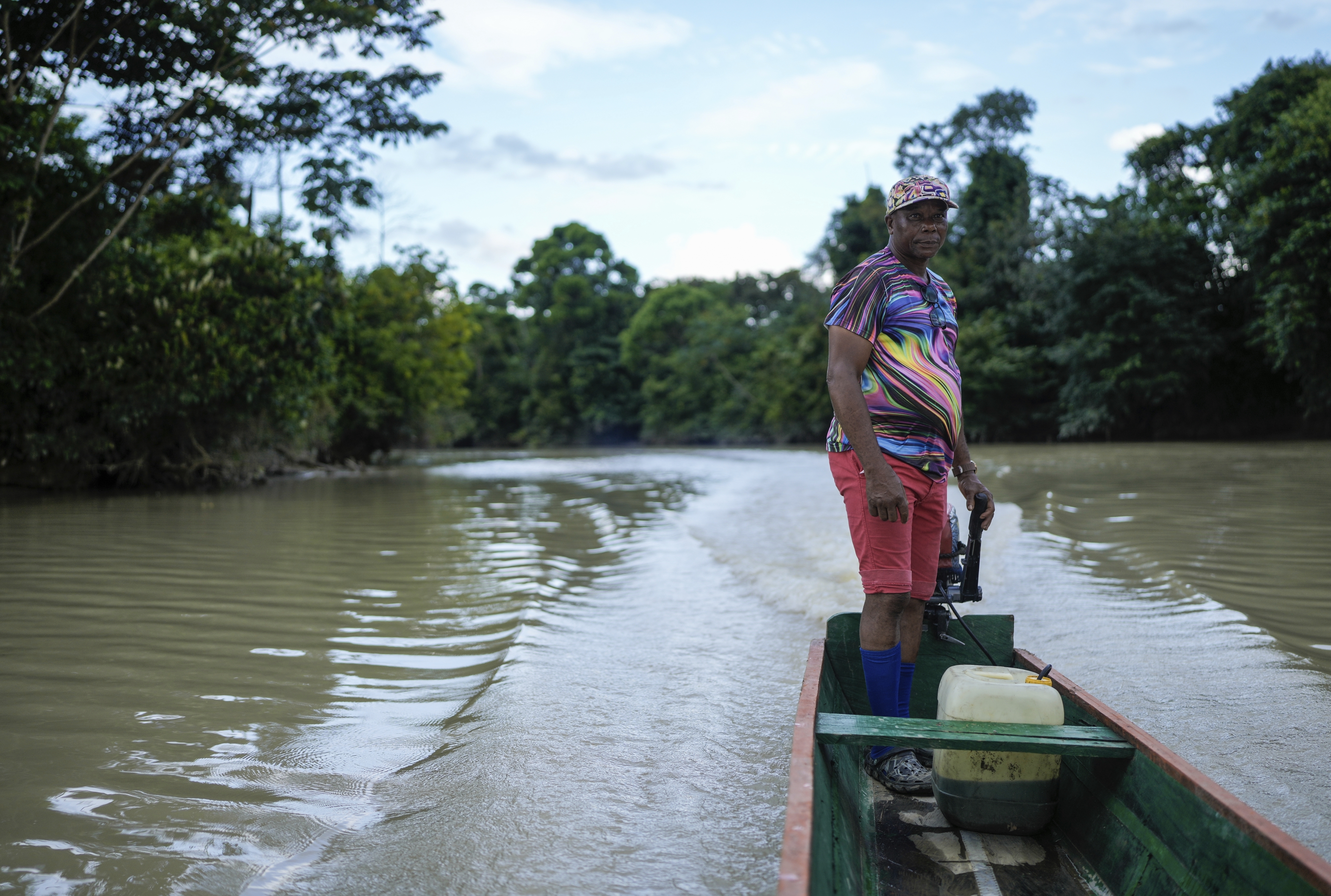 Bernardino Mosquera, a river guardian, maneuvers his boat on the Quito River, near Paimado, Colombia, Monday, Sept. 23, 2024. (AP Photo/Ivan Valencia)