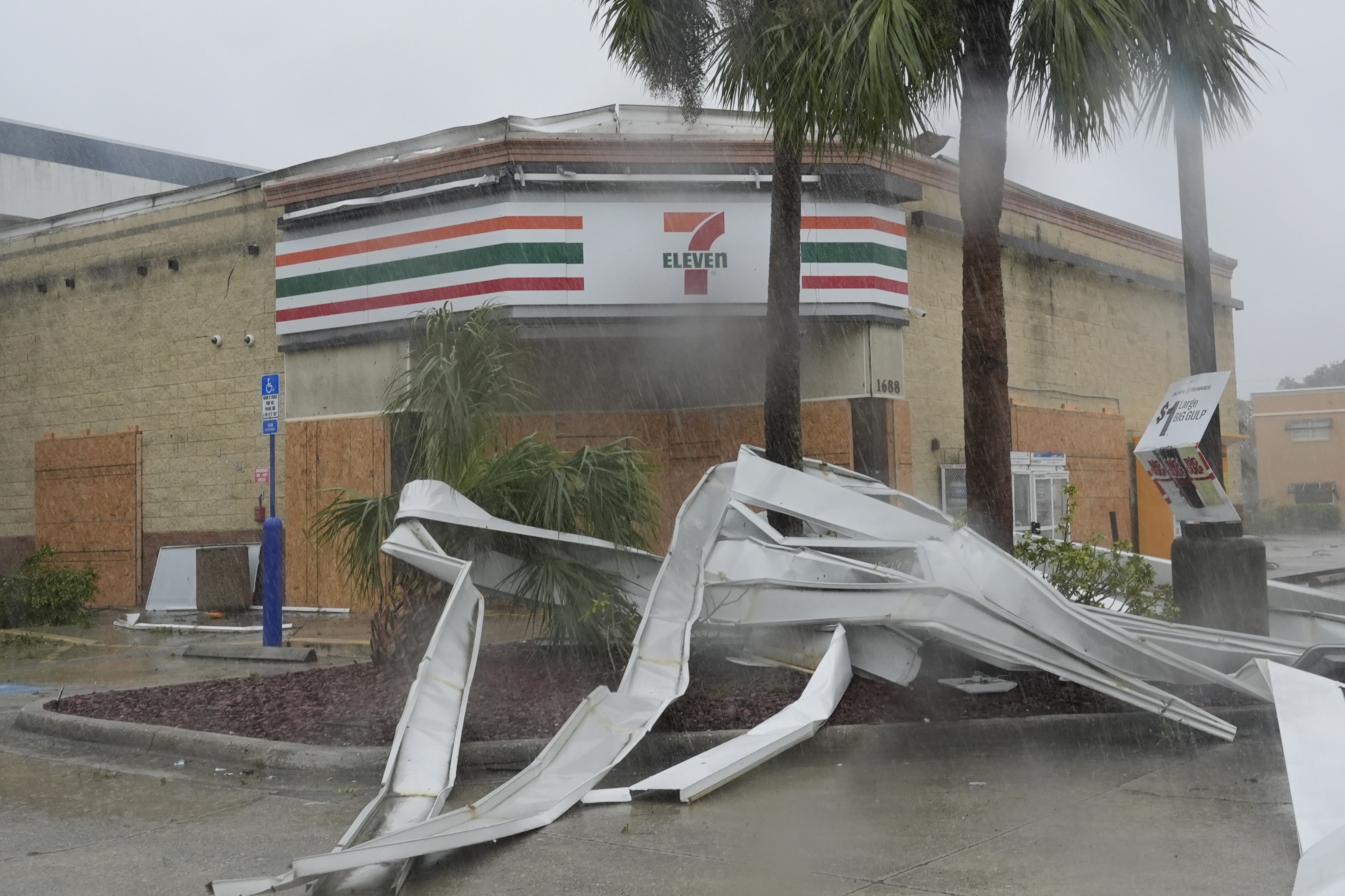 An apparent tornado caused by Hurricane Milton, tore the awning off a 7-Eleven convenient store, Wednesday, Oct. 9, 2024, in Cape Coral, Fla. (AP Photo/Marta Lavandier)