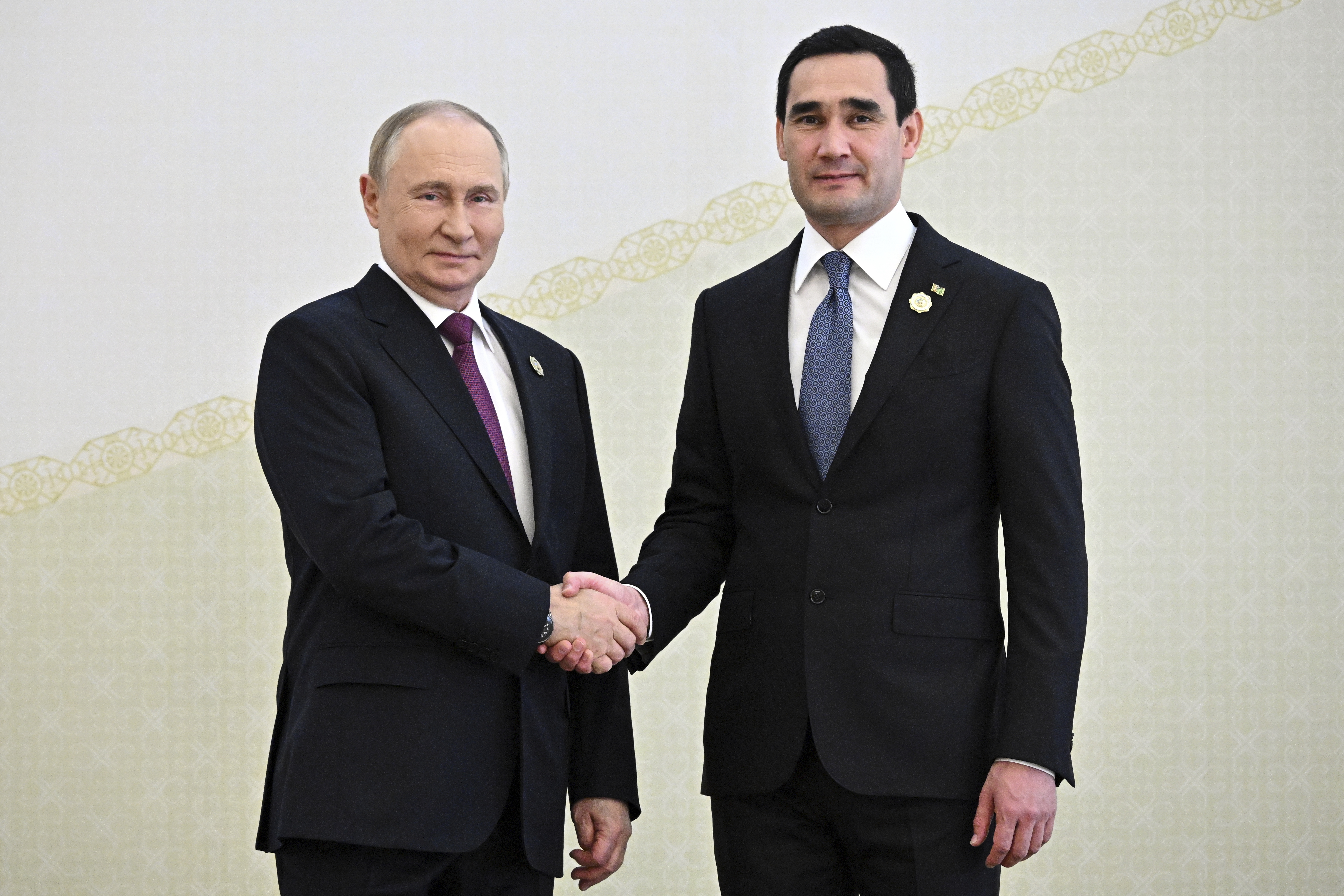 Russian President Vladimir Putin, left, and Turkmenistan's President Serdar Berdimuhamedov shake hands during their meeting on the sidelines of the International Forum "The Interconnection of Times and Civilizations – the basis of peace and development" dedicated to the 300th anniversary of the birth of the outstanding Turkmen poet and thinker Magtymguly Fragi in Ashgabat, Turkmenistan, Friday, Oct. 11, 2024. (Sergei Bobylev, Sputnik, Kremlin Pool Photo via AP)