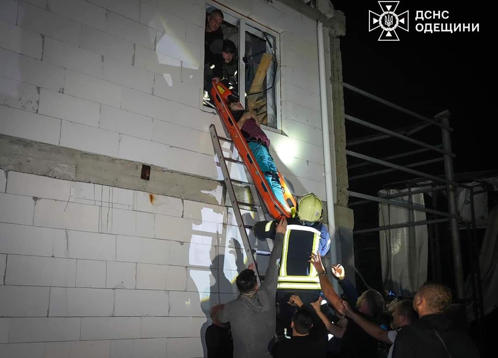 In this photo provided by the Ukrainian Emergency Service, Emergency workers carry a wounded resident after Russian missile attack in Odesa, Ukraine, late Thursday, Oct. 10, 2024. Four Russian missile and drone attacks on the Odesa region this week have killed 14 people and wounded around 20, according to local officials. (Ukrainian Emergency Service via AP)