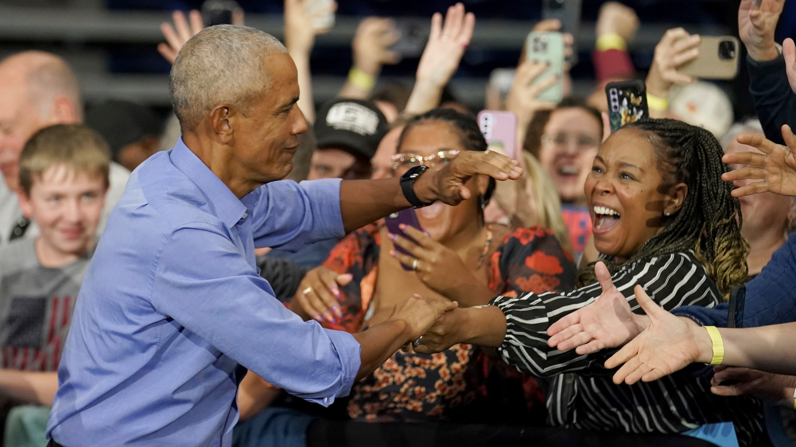 Former President Barack Obama greets attendees before speaking at a campaign rally supporting Democratic presidential nominee Vice President Kamala Harris, Thursday, Oct. 10, 2024, at the University of Pittsburgh's Fitzgerald Field House in Pittsburgh. (AP Photo/Matt Freed)