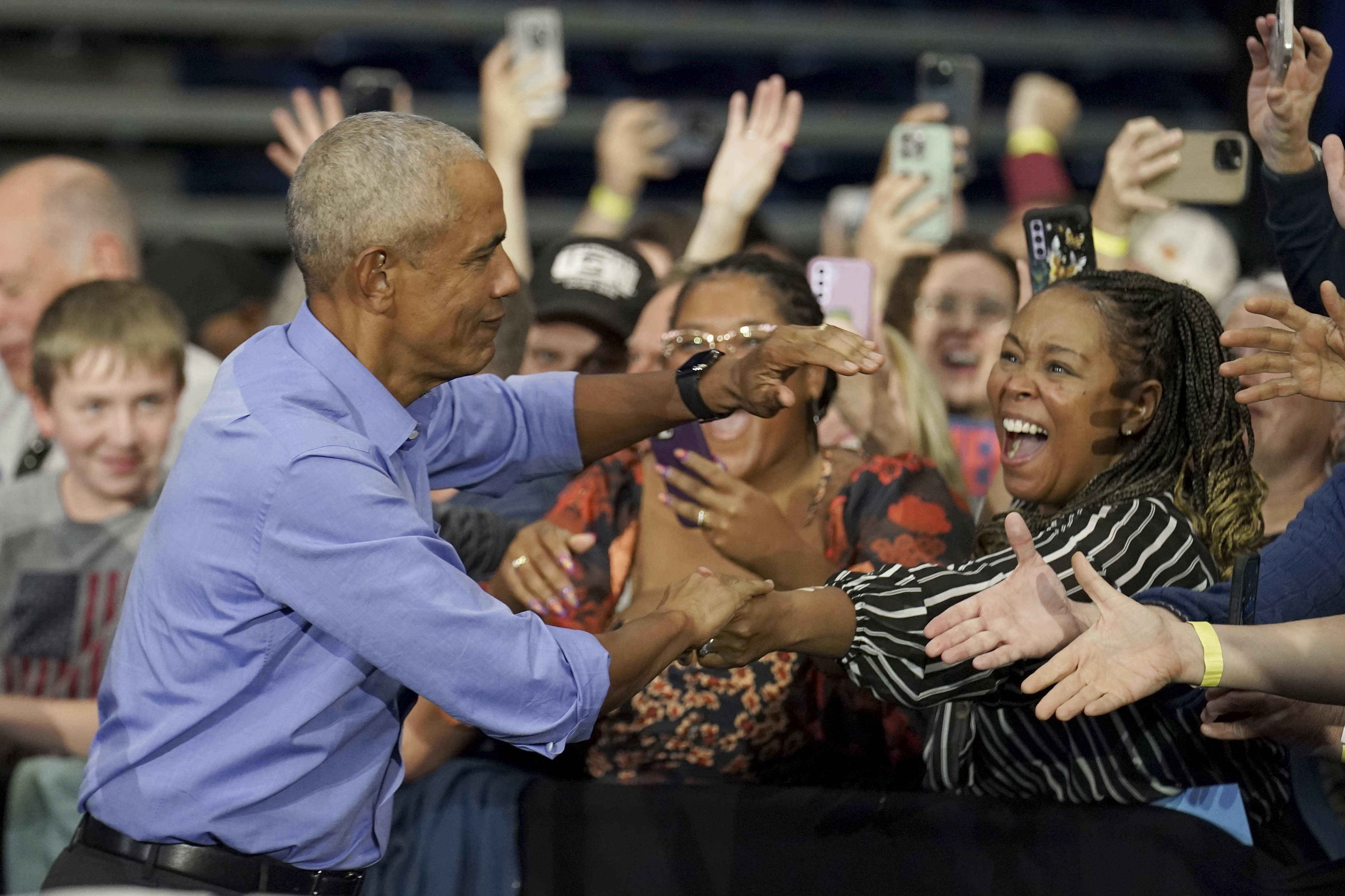 Former President Barack Obama greets attendees before speaking at a campaign rally supporting Democratic presidential nominee Vice President Kamala Harris, Thursday, Oct. 10, 2024, at the University of Pittsburgh's Fitzgerald Field House in Pittsburgh. (AP Photo/Matt Freed)