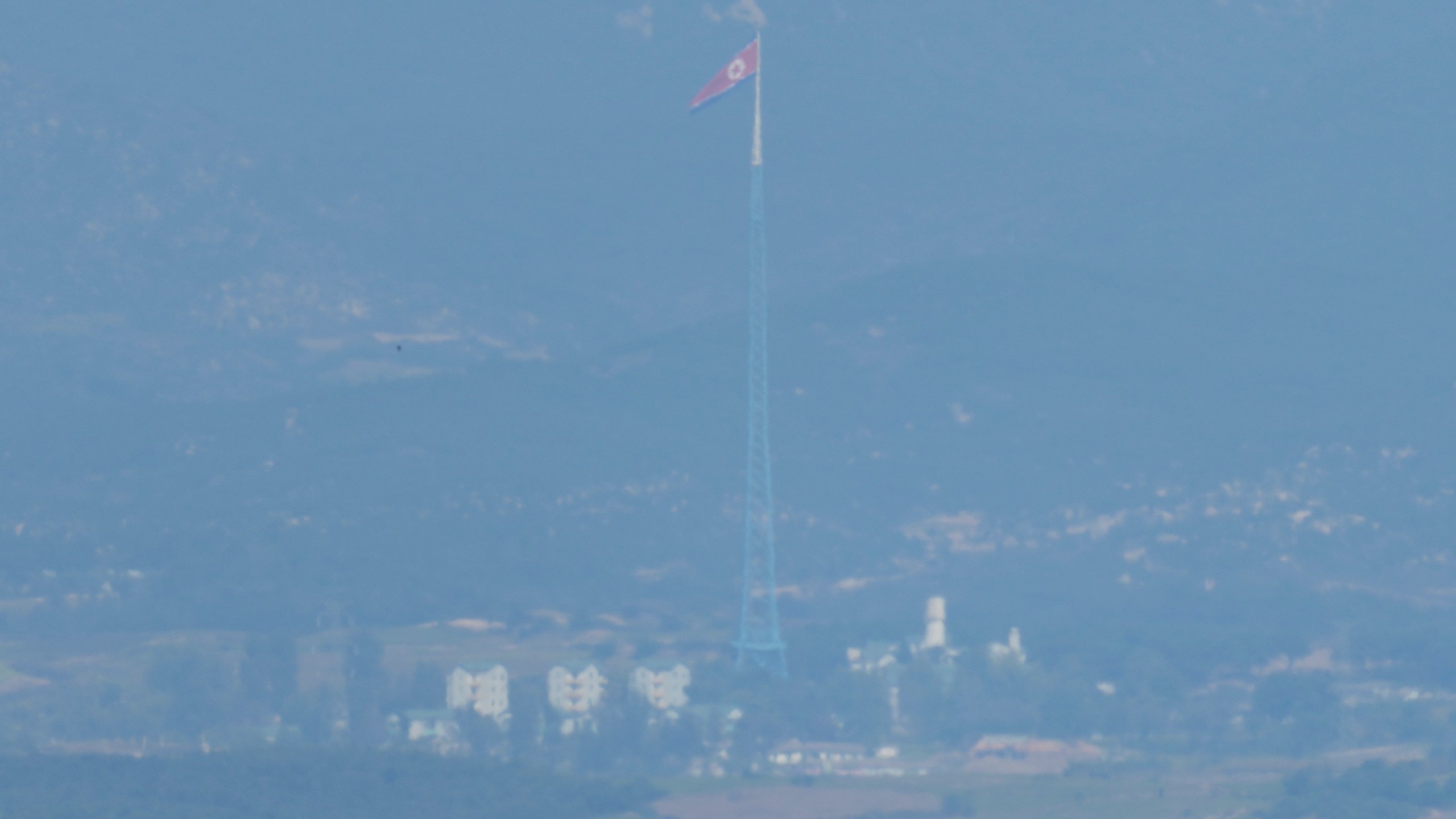 A North Korean flag flutters in the wind atop a 160-meter (525-foot) tower in the North's Kijong-dong village near the truce village of Panmunjom, seen from Paju, South Korea, near the border with North Korea, Wednesday, Oct. 9, 2024. (AP Photo/Lee Jin-man)