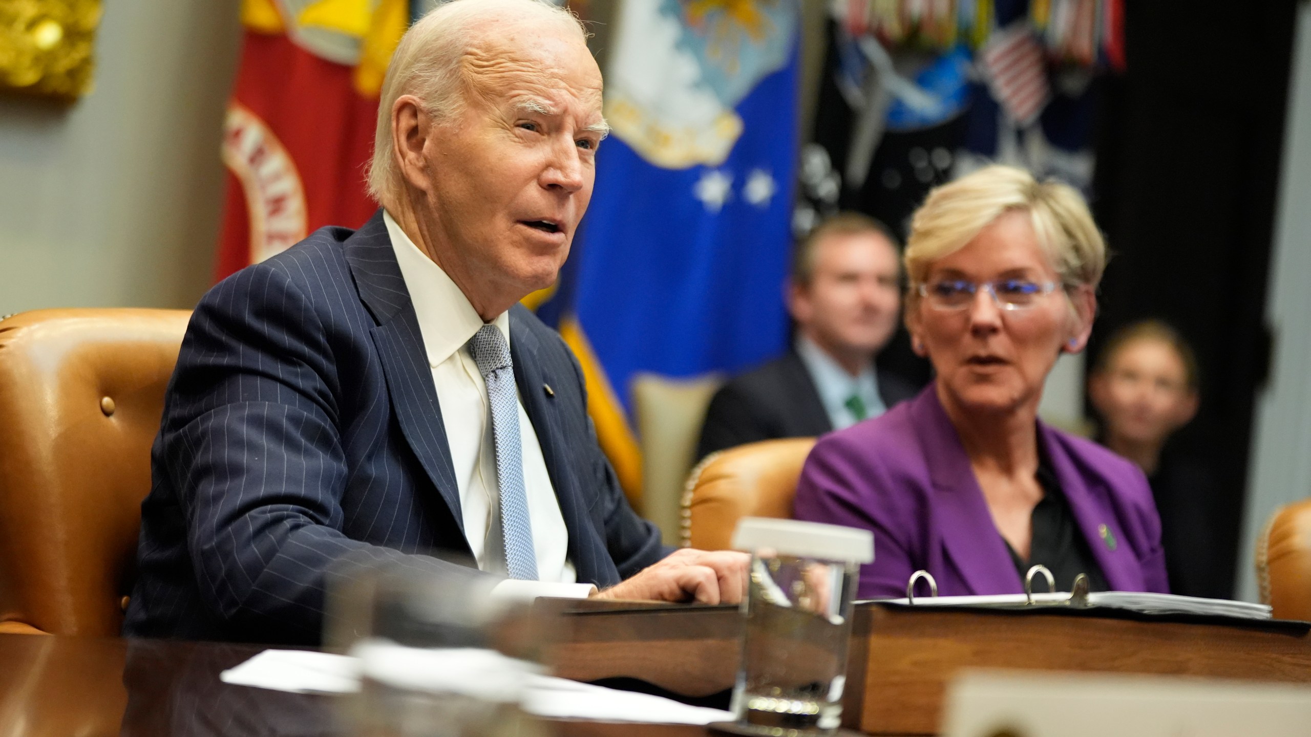 President Joe Biden speaks about the federal government's response to Hurricanes Milton and Helene as as Energy Secretary Jennifer Granholm listens, in the Roosevelt Room of the White House, Friday, Oct. 11, 2024, in Washington. (AP Photo/Manuel Balce Ceneta)