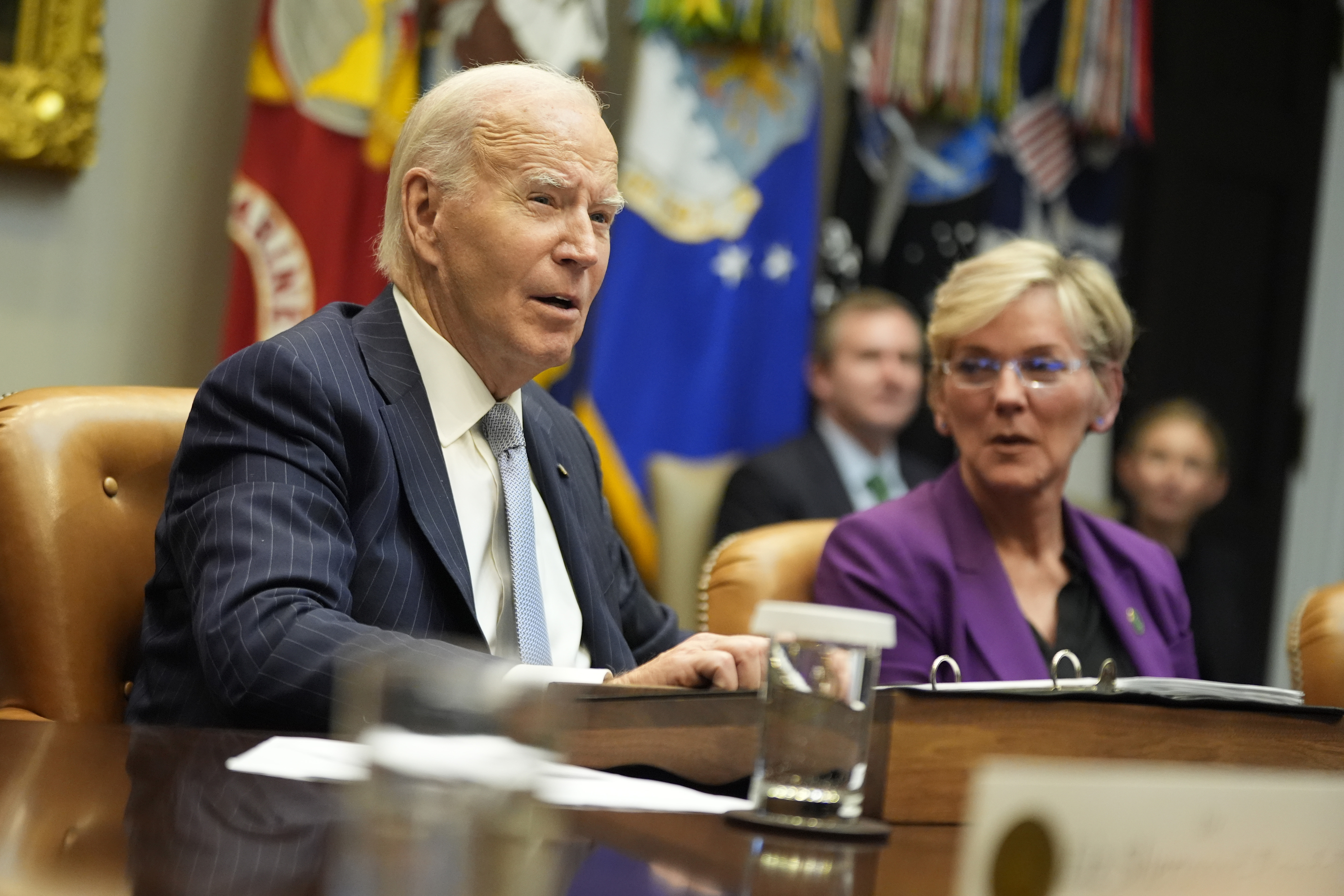 President Joe Biden speaks about the federal government's response to Hurricanes Milton and Helene as as Energy Secretary Jennifer Granholm listens, in the Roosevelt Room of the White House, Friday, Oct. 11, 2024, in Washington. (AP Photo/Manuel Balce Ceneta)