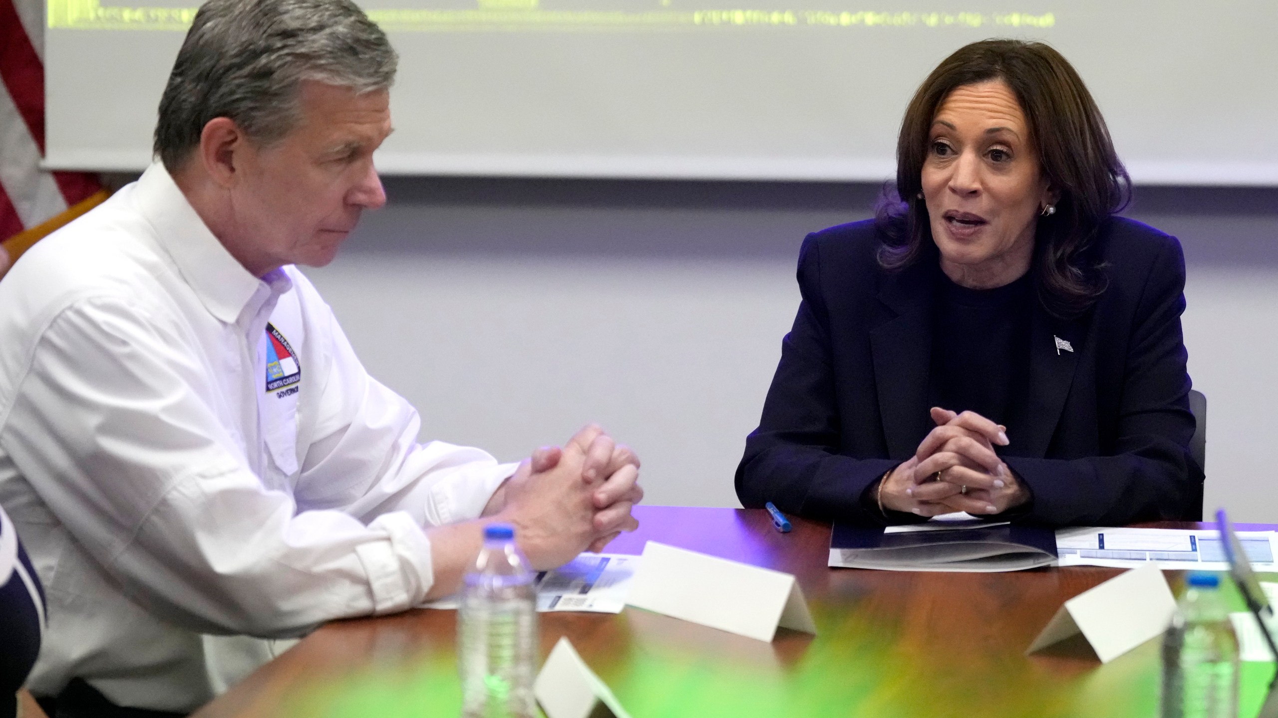 Democratic presidential nominee Vice President Kamala Harris, right, receives a briefing from North Carolina Gov. Roy Cooper on the damage from Hurricane Helene, Saturday, October 5, 2024 in Charlotte, N.C. (AP Photo/Chris Carlson)