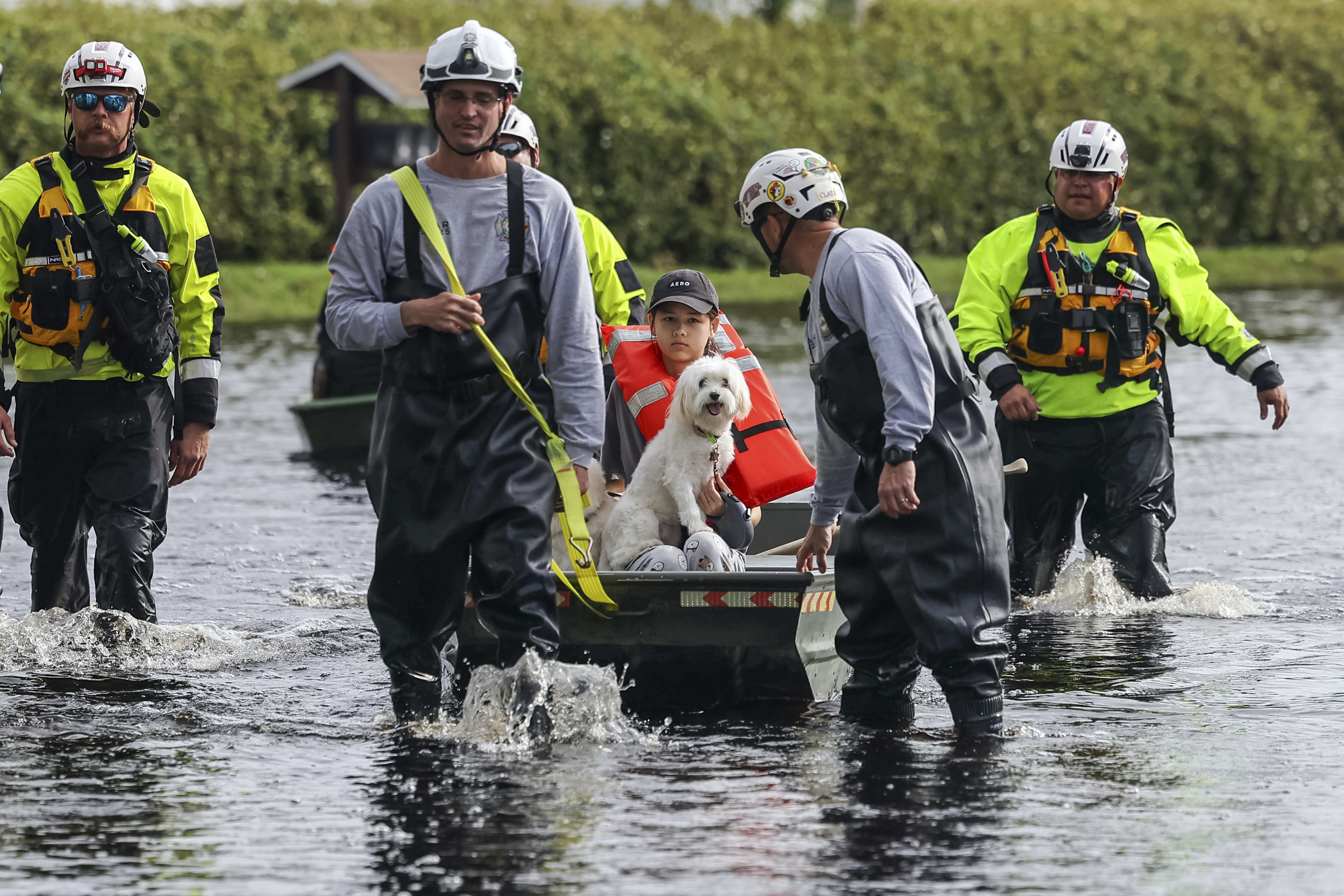 Amy Bishop is evacuated from her home by Pasco County Fire and Rescue and Sheriff's Office teams as waters rise in her neighborhood after Hurricane Milton caused the Anclote River to flood, Friday, Oct. 11, 2024, in New Port Richey, Fla. (AP Photo/Mike Carlson)