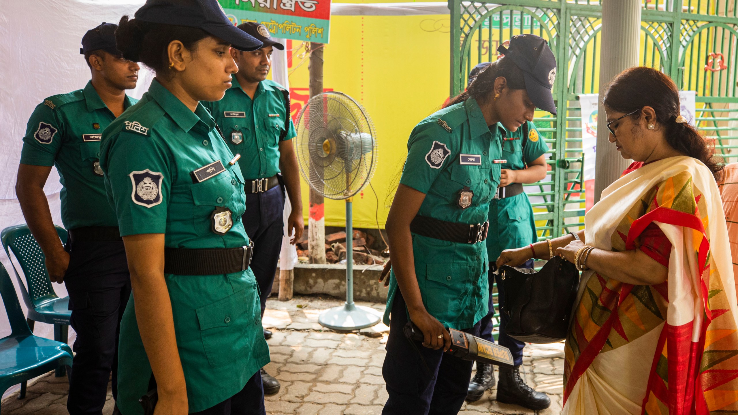 A police woman checks a bag of a woman devotee at the Dhakeshwari National Temple during the Durgapuja festival in Dhaka, Bangladesh, on Oct. 10, 2024. (AP Photo/Rajib Dhar)