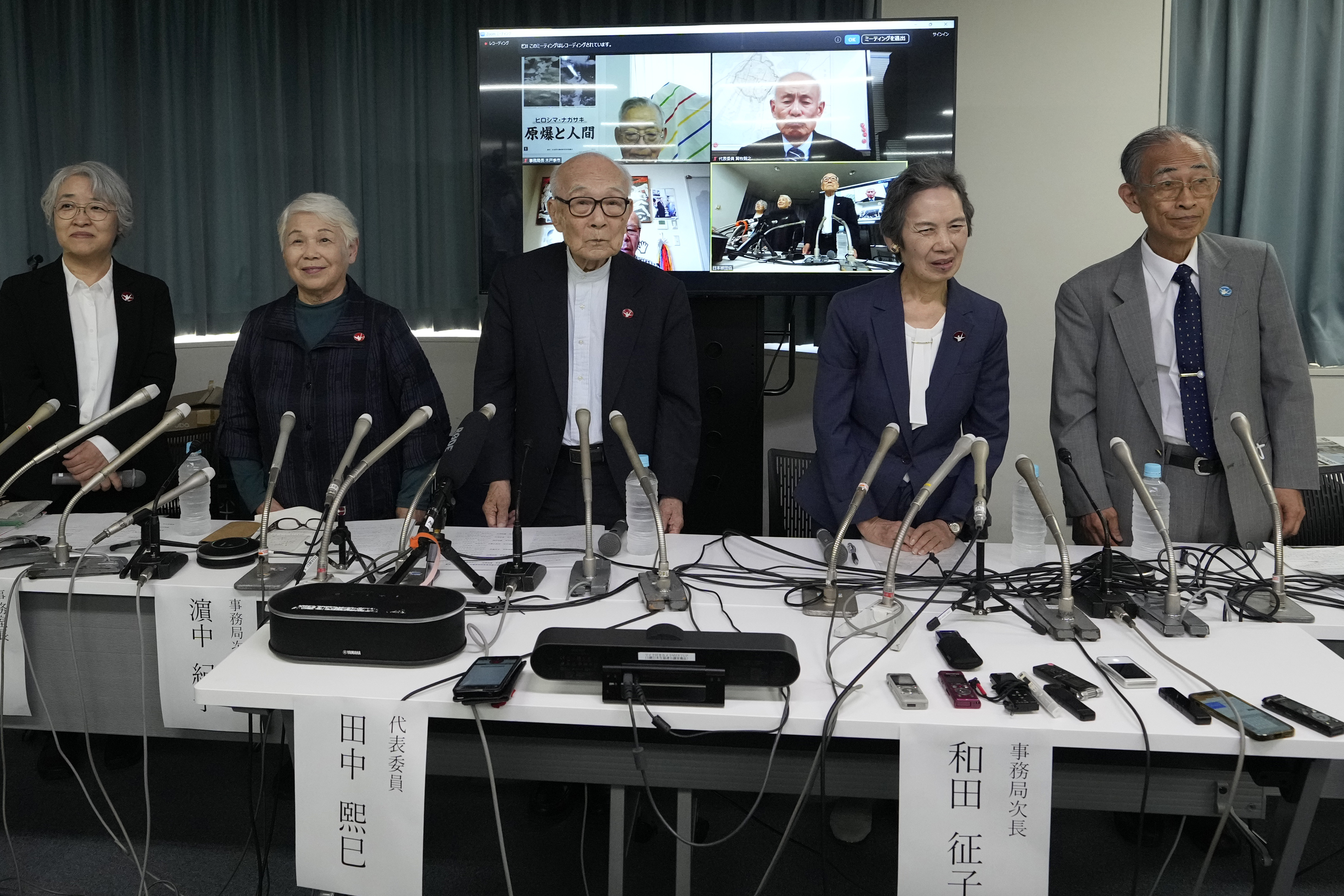 Terumi Tanaka, center, co-chairperson of Nihon Hidankyo and other senior members attend a press conference in Tokyo, Saturday, Oct. 12, 2024, a day after Nihon Hidankyo, an organization of survivors of the two U.S. atomic bombings, won the Nobel Peace Prize. Other members from second left to right, assistant Secretary Generals Toshiko Hamanaka, Masako Wada, and Jiro Hamasumi.(AP Photo/Hiro Komae)