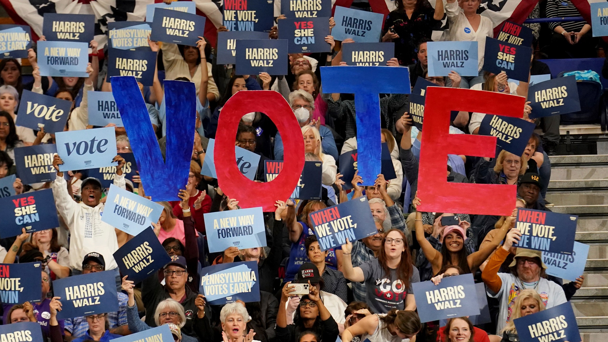 Attendees hold signs as former President Barack Obama speaks during a campaign rally supporting Democratic presidential nominee Vice President Kamala Harris, Thursday, Oct. 10, 2024, at the University of Pittsburgh's Fitzgerald Field House in Pittsburgh. (AP Photo/Matt Freed)