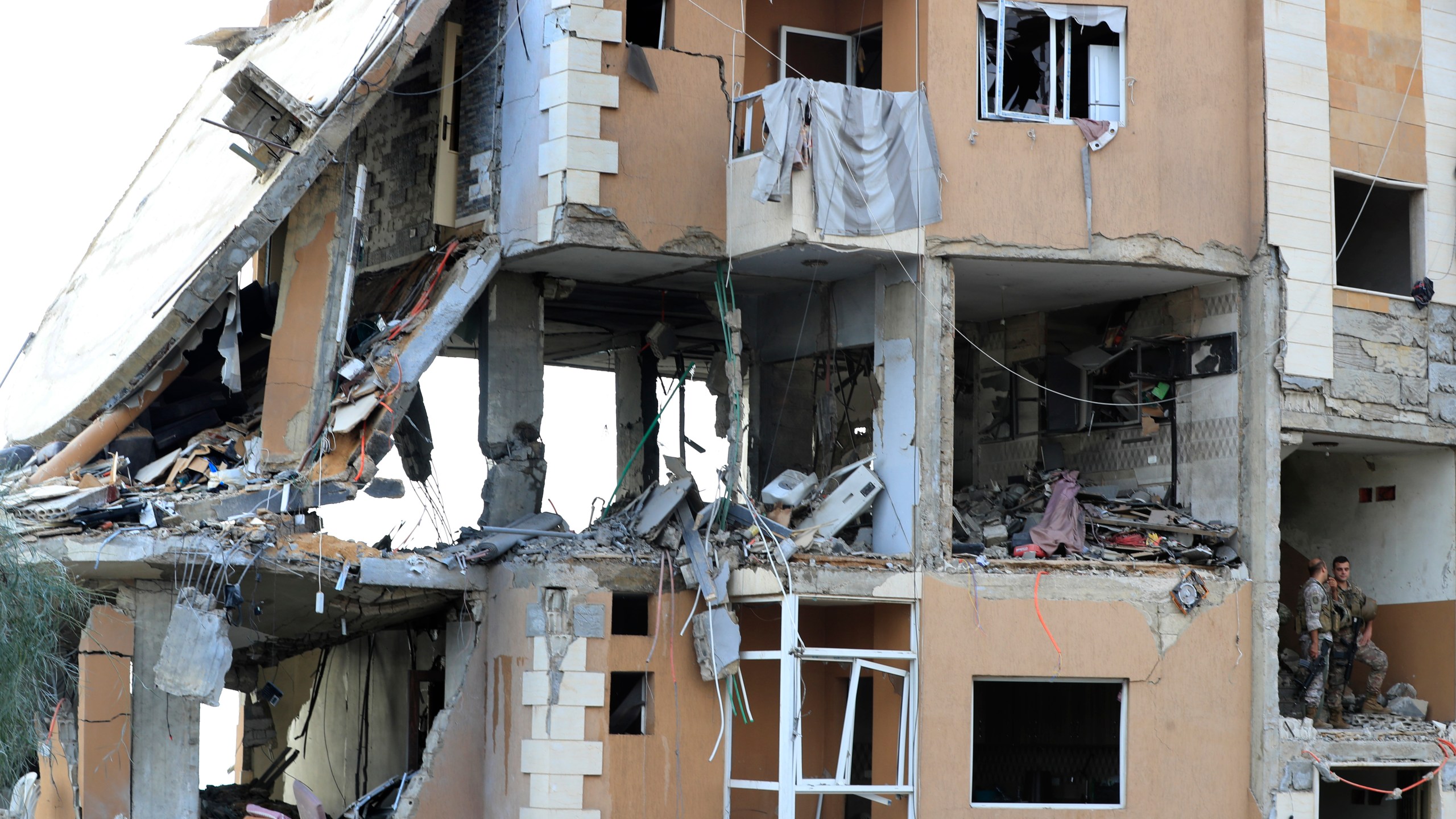 Lebanese army soldiers stand guard on a destroyed building hit by an Israeli airstrike, in Barja village, south of Beirut, Lebanon, Saturday, Oct. 12, 2024. (AP Photo/Mohammed Zaatari)