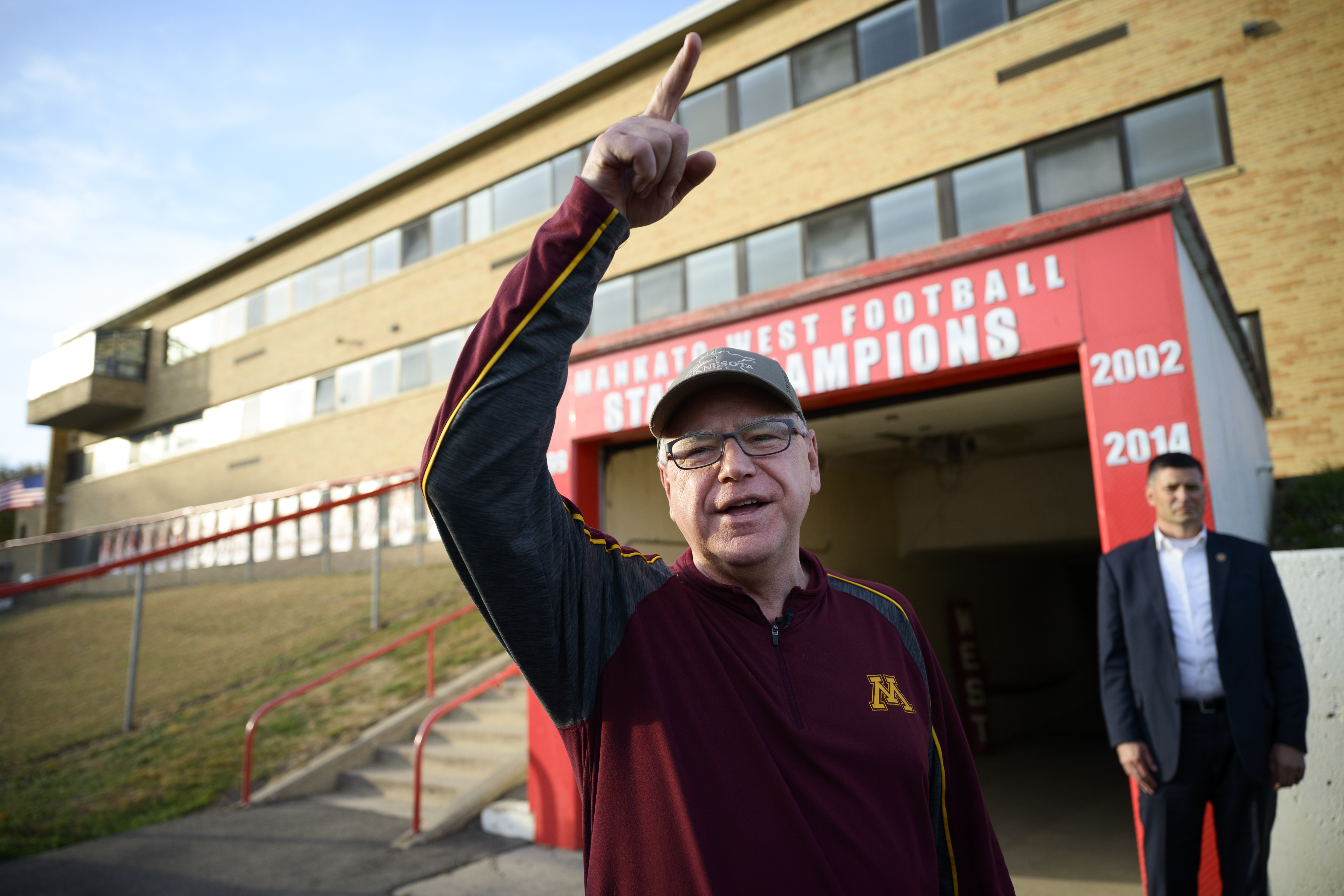 Vice Presidential candidate and Minnesota Gov. Tim Walz greets people in the football team tunnel Friday, Oct. 11, 2024 at Mankato West High School in Mankato, Minn. Gov. Walz visited Friday's Mankato East-West rivalry game. Walz was a defensive coach for Mankato West's 1999 state championship team. (Aaron Lavinsky/Star Tribune via AP)