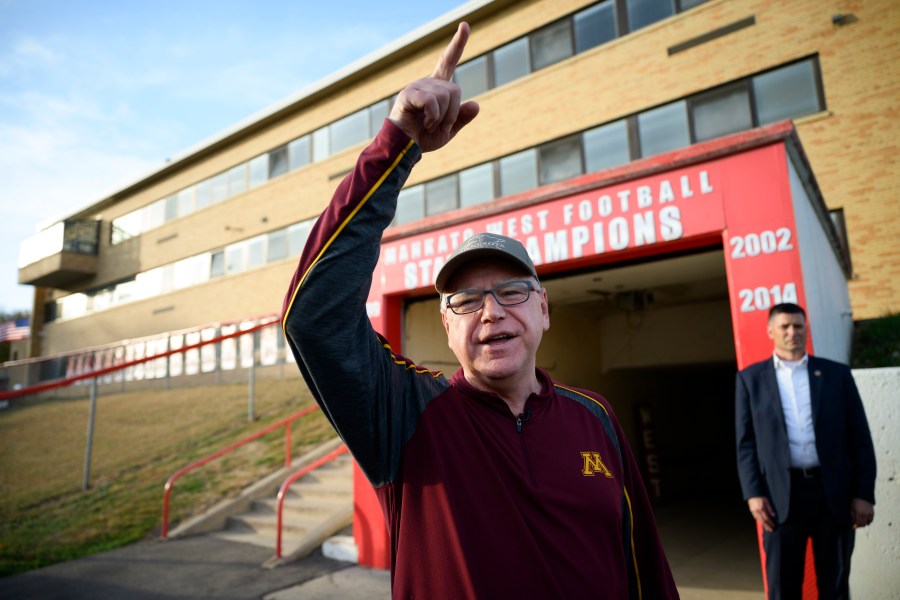 Vice Presidential candidate and Minnesota Gov. Tim Walz greets people in the football team tunnel Friday, Oct. 11, 2024 at Mankato West High School in Mankato, Minn. Gov. Walz visited Friday's Mankato East-West rivalry game. Walz was a defensive coach for Mankato West's 1999 state championship team. (Aaron Lavinsky/Star Tribune via AP)