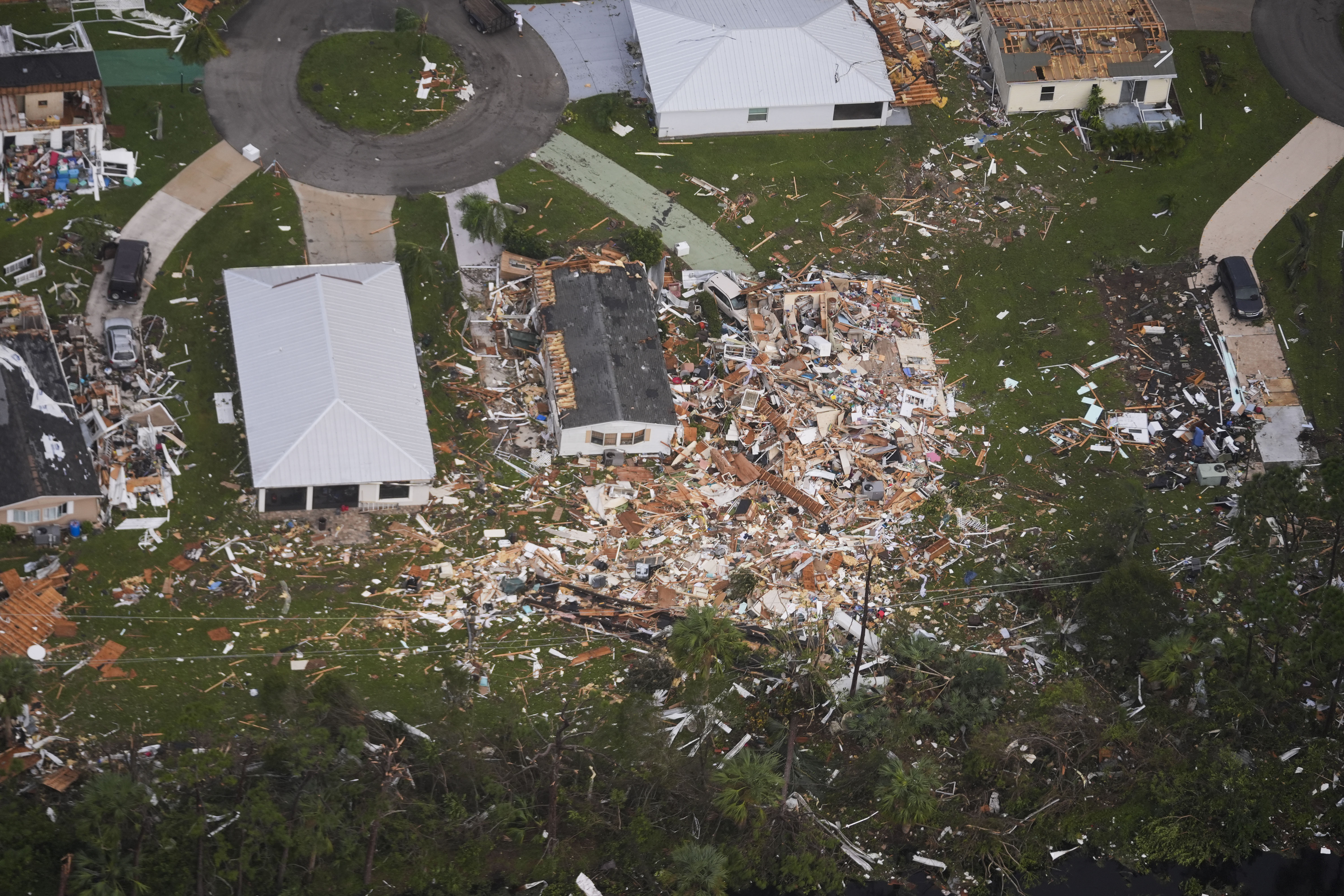 Neighborhoods destroyed by tornadoes are seen in this aerial photo in the aftermath of Hurricane Milton, Thursday, Oct. 10, 2024, in Fort Pierce, Fla. (AP Photo/Gerald Herbert)