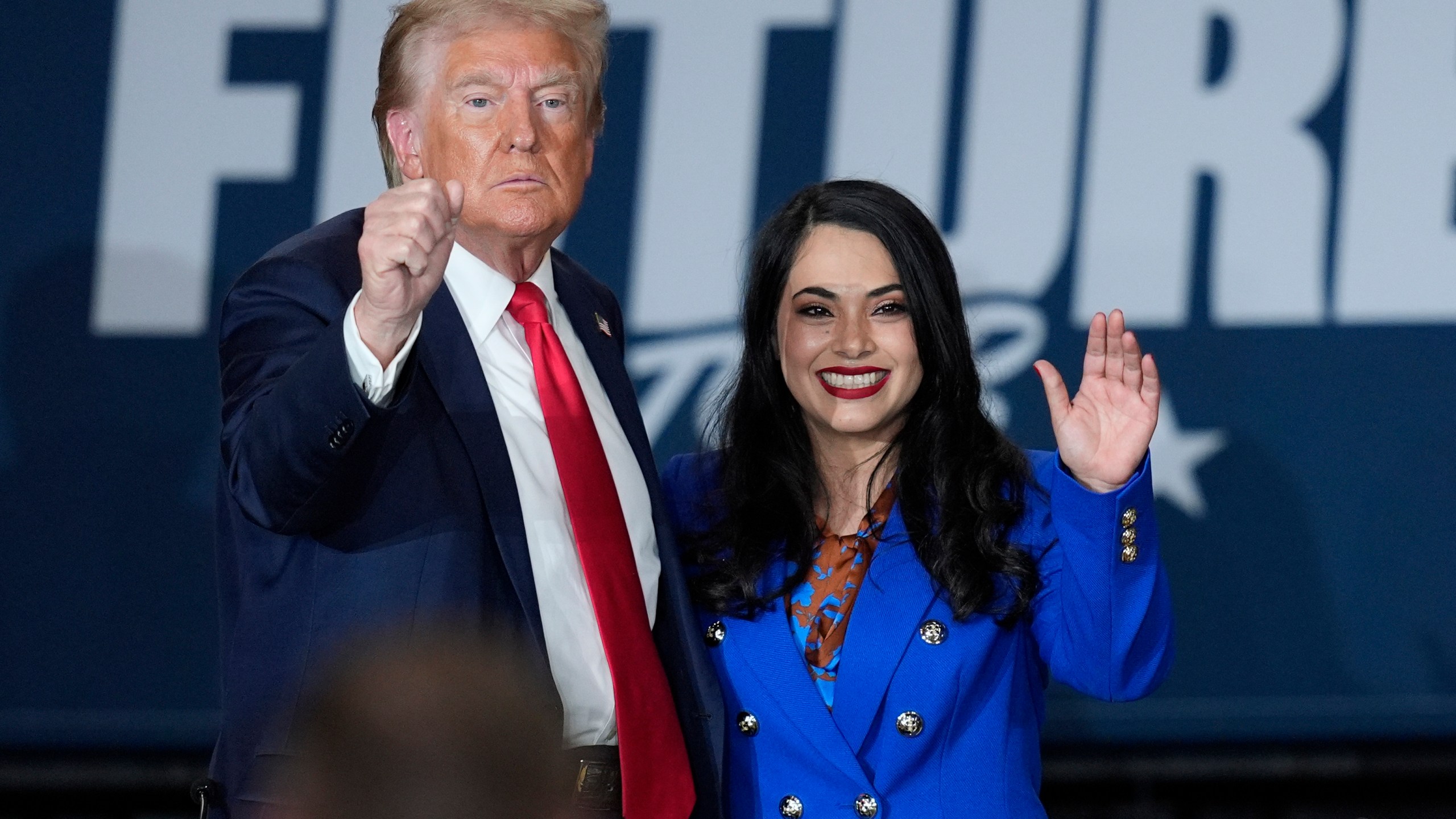 Republican presidential nominee former President Donald Trump, left, poses with Republican House candidate Mayra Flores at a campaign event at Beauty Society, Saturday, Oct. 12, 2024, in North Las Vegas, Nev. (AP Photo/John Locher)