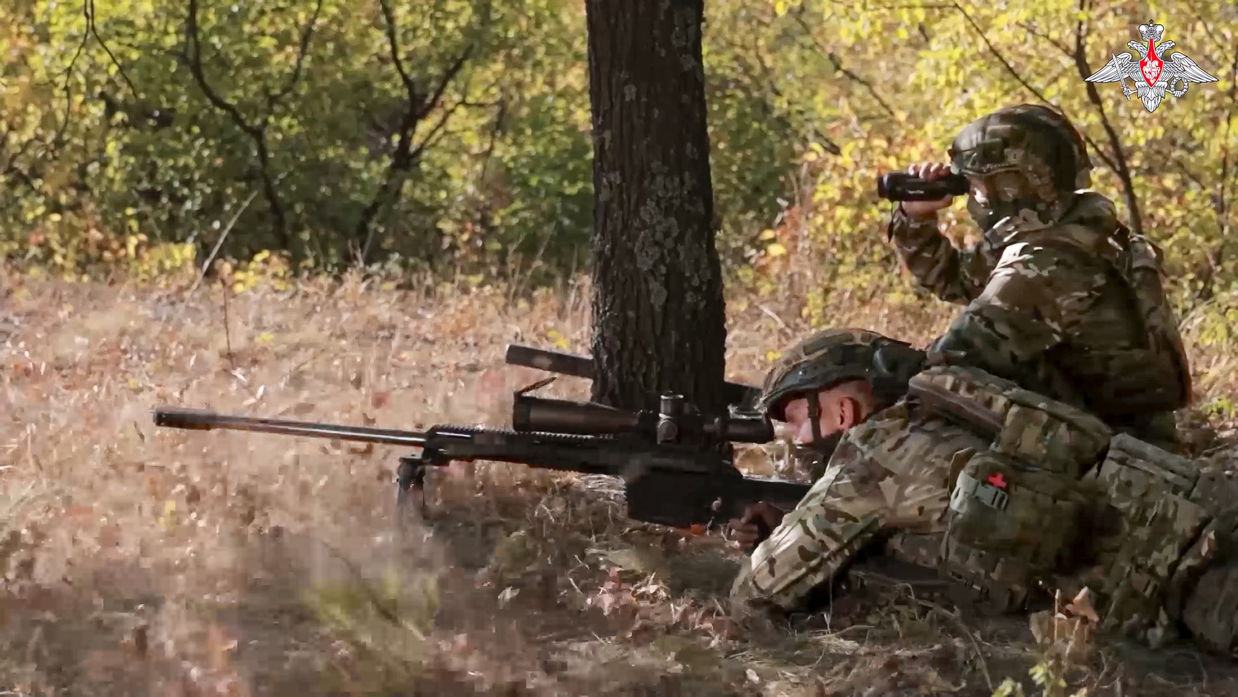 In this image made from video released by the Russian Defense Ministry on Friday, Oct. 11, 2024, a Russian sniper, in an undisclosed location, fires towards Ukrainian forces. (Russian Defense Ministry Press Service via AP)