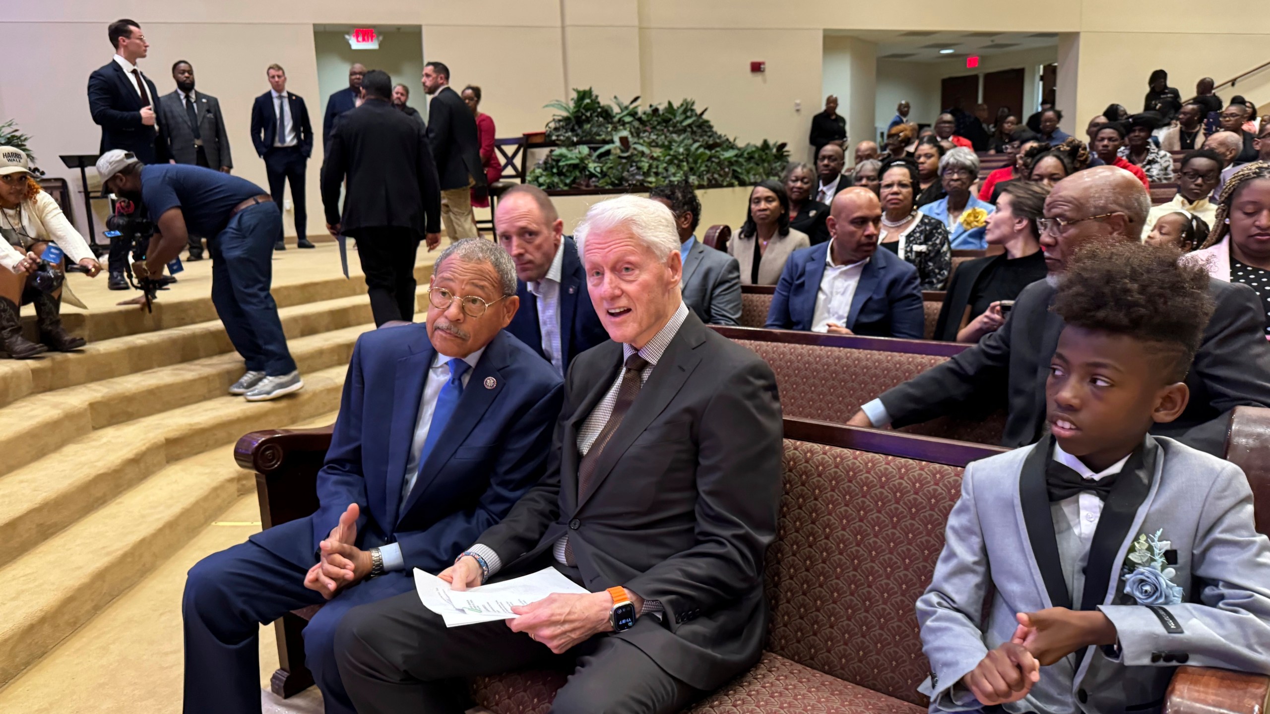 Former President Bill Clinton and U.S. Congressman Sanford Bishop talk at Mt. Zion Baptist Church in Albany, Ga. on Sunday, Oct. 13, 2024. (AP Photo/Charlotte Kramon)