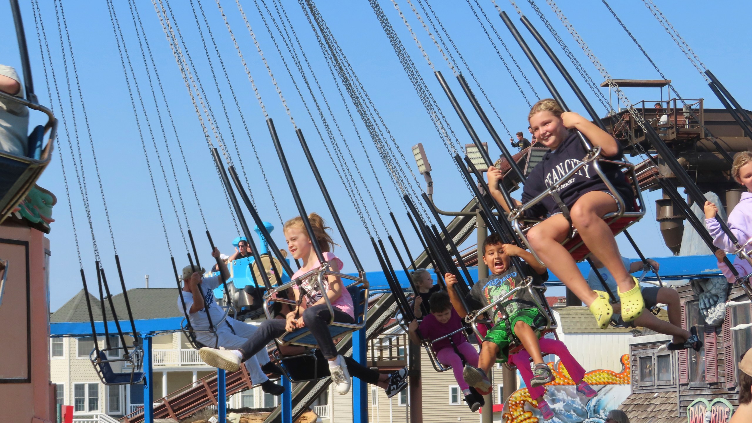 People ride the flying chair attraction at Gillian's Wonderland, the popular amusement park on the boardwalk in Ocean City, N.J., during its final day of operation before shutting down for good, Sunday, Oct. 13, 2024. (AP Photo/Wayne Parry)