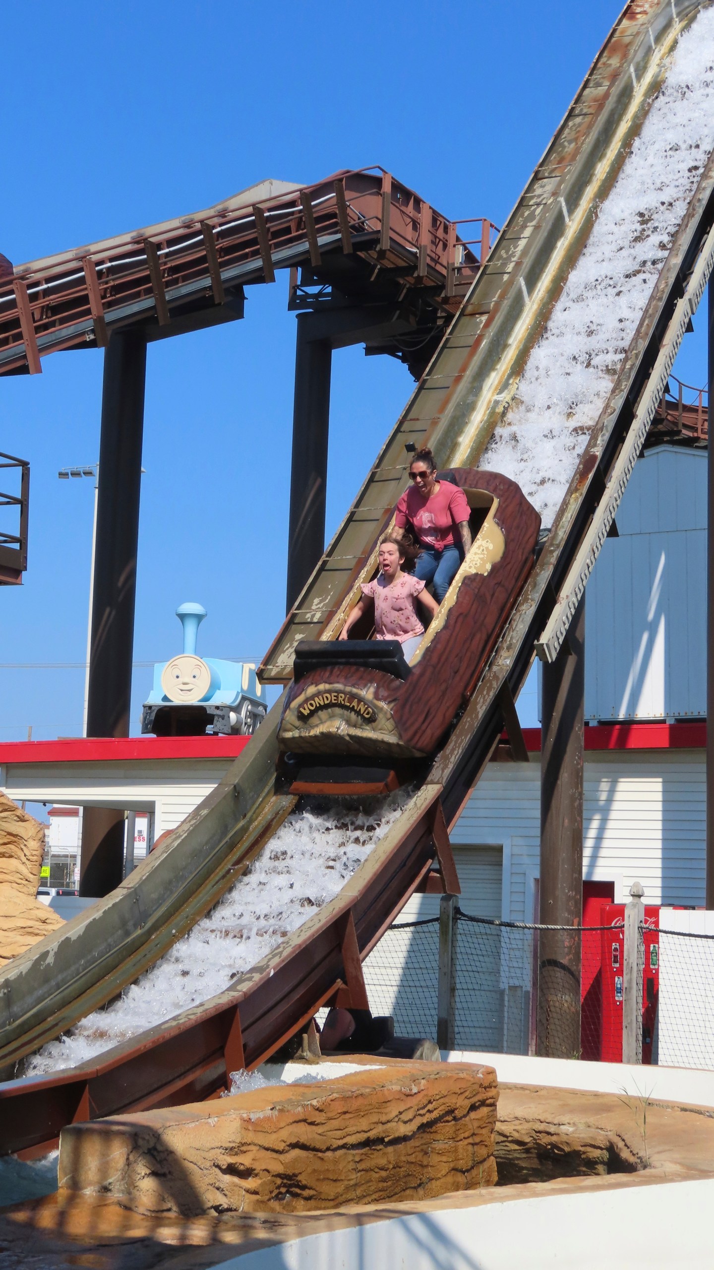 People ride the log flume at Gillian's Wonderland, the popular amusement park on the boardwalk in the Ocean City, N.J., during its final day of operation before shutting down for good, Sunday, Oct. 13, 2024. (AP Photo/Wayne Parry)