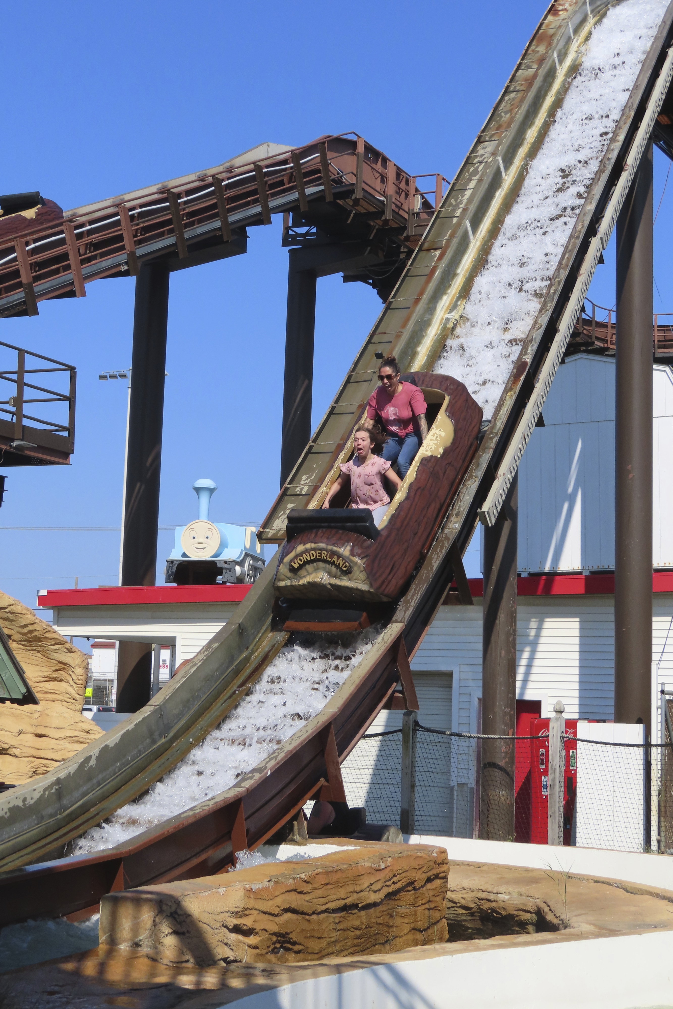 People ride the log flume at Gillian's Wonderland, the popular amusement park on the boardwalk in the Ocean City, N.J., during its final day of operation before shutting down for good, Sunday, Oct. 13, 2024. (AP Photo/Wayne Parry)