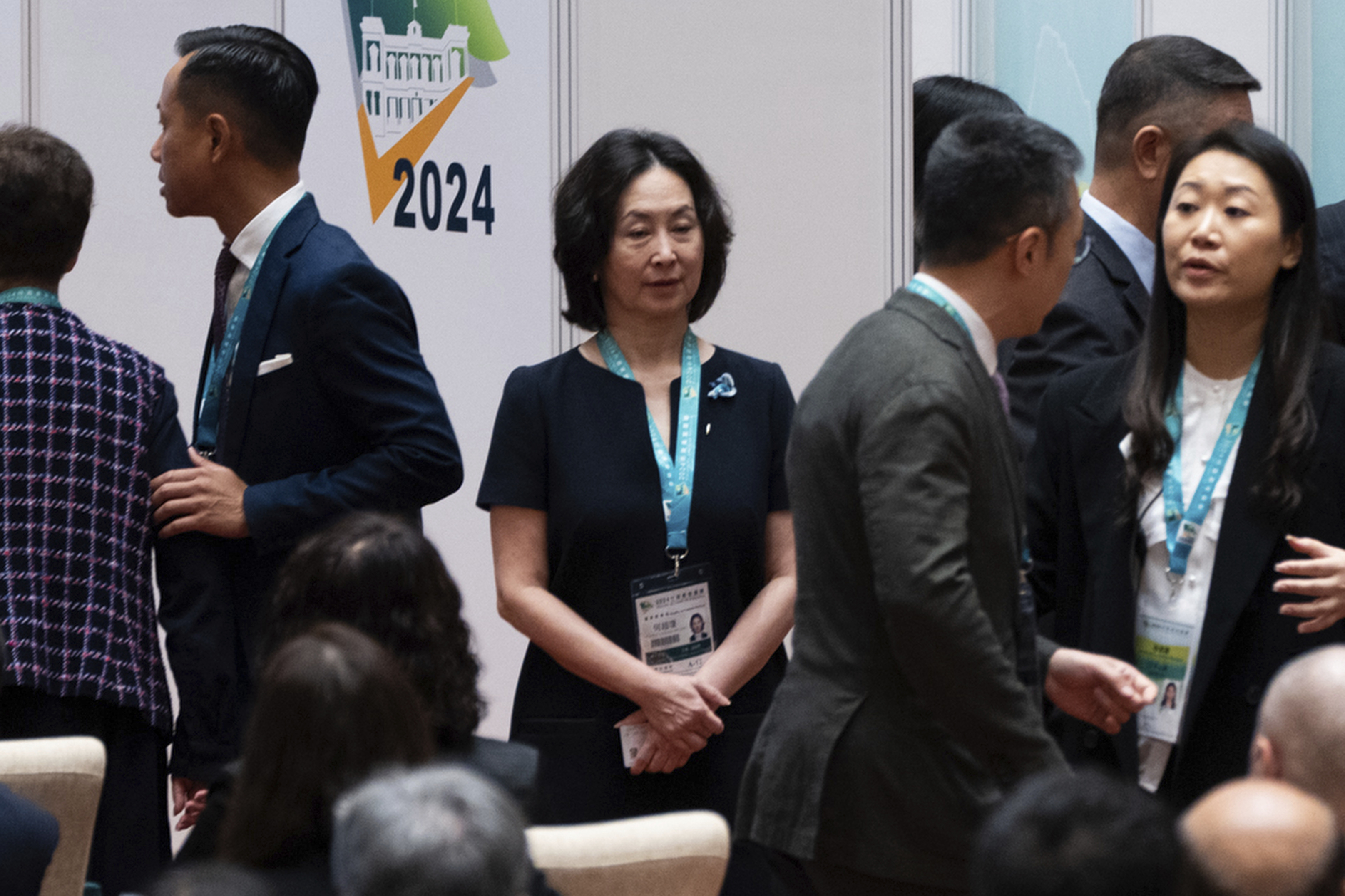 Shun Tak Holdings' group executive chairperson Pansy Ho, center, daughter of late casino tycoon Stanley Ho, waits in line to vote during the chief executive election in Macao, Sunday, Oct. 13, 2024. (AP Photo/Bertha Wang)