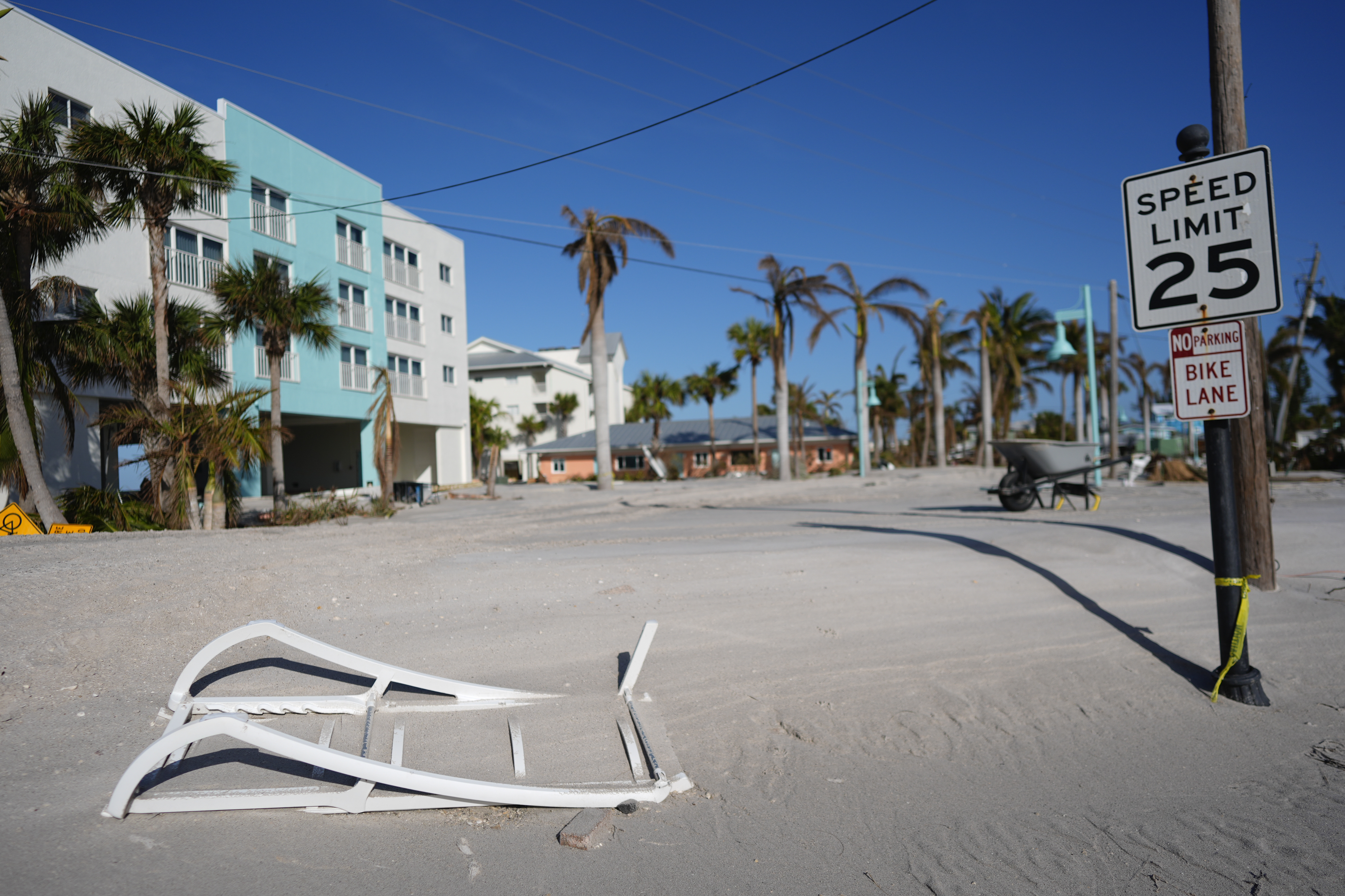 Sand covers a remaining stretch of the main road in southern Manasota Key, in Englewood, Fla., as Charlotte County crews work to clear it, following the passage of Hurricane Milton, Sunday, Oct. 13, 2024. (AP Photo/Rebecca Blackwell)