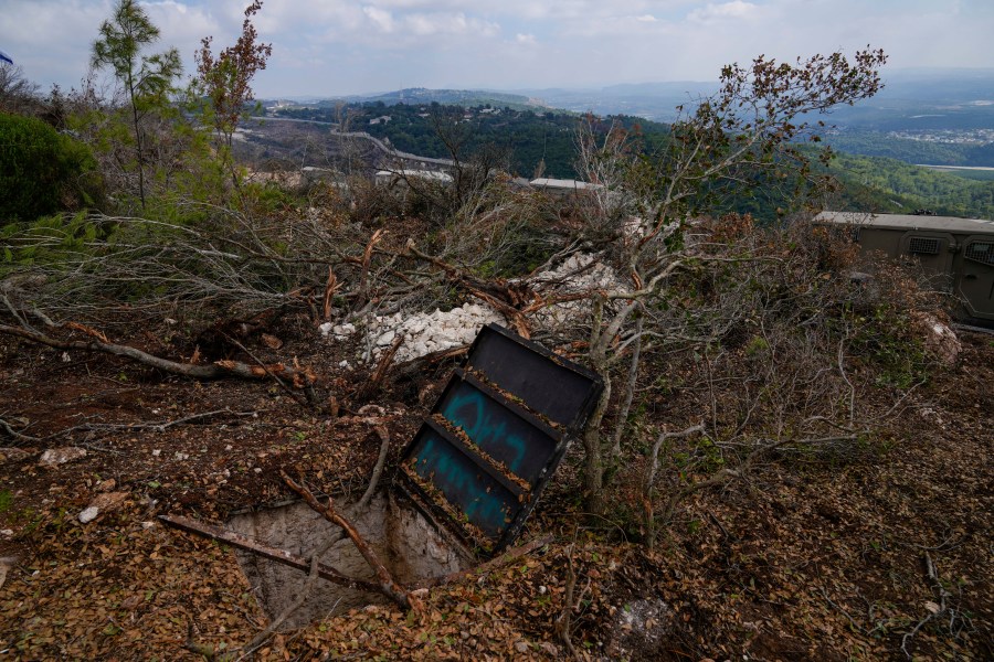 Israeli soldiers display what they say is an entrance to a Hezbollah tunnel found during their ground operation in southern Lebanon, near the border with Israel, Sunday, Oct. 13, 2024. (AP Photo/Sam McNeil)