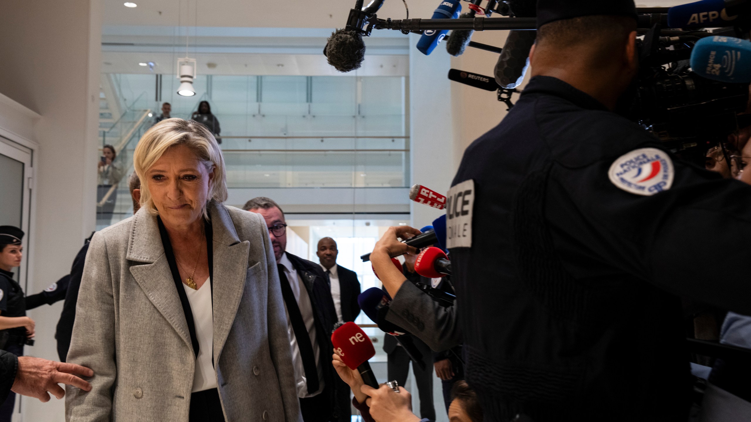 French far-right leader Marine Le Pen walks past the media as she arrives at the court house in Paris, Monday, Sept. 30, 2024. (AP Photo/Louise Delmotte)