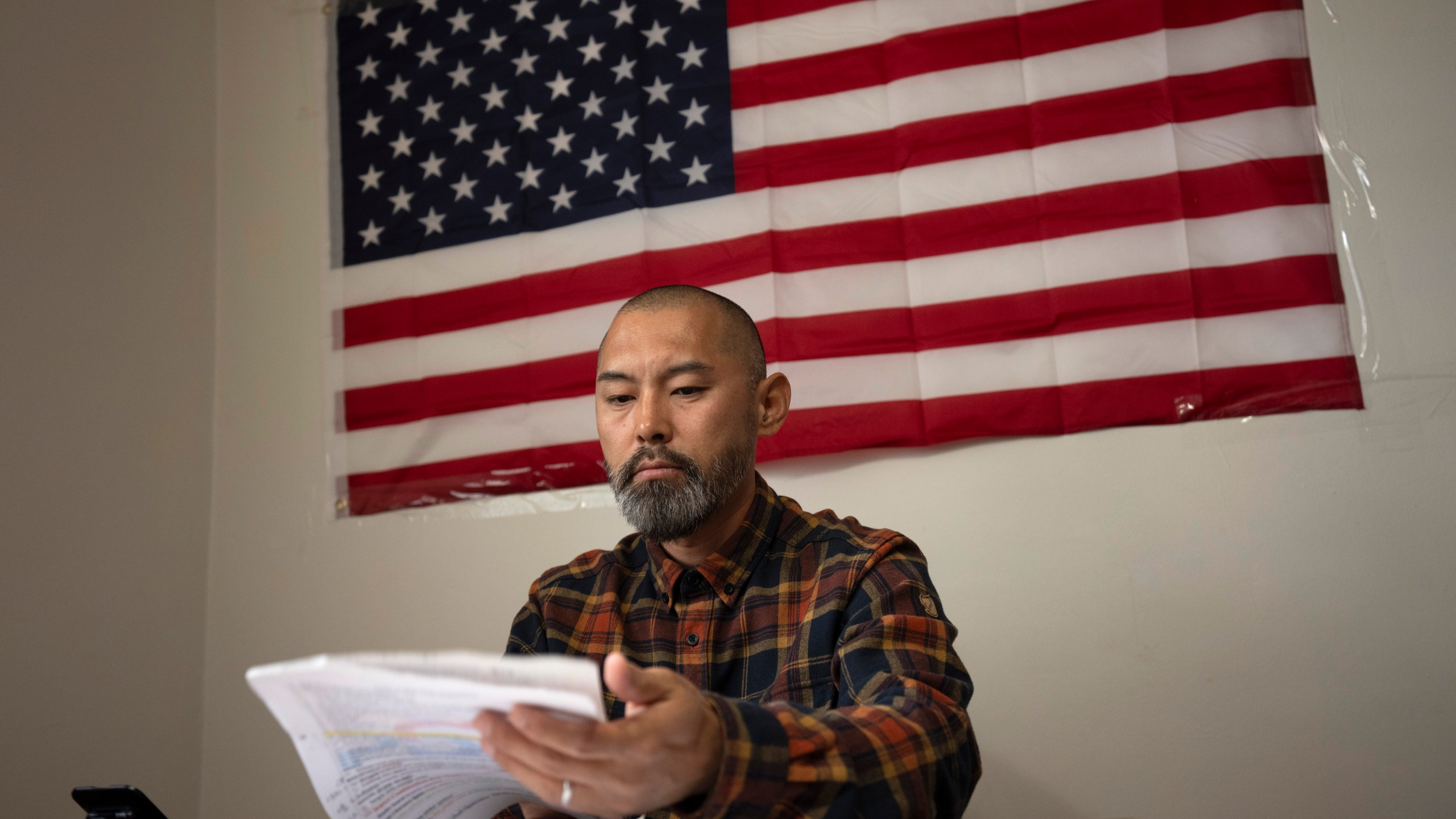 FILE - Chinese migrant Li Kai aka Khaled, an ethnic Hui Muslim, studies for a Commercial Driving License in his apartment in Flushing, New York, May 3, 2024. Li Kai came to the U.S. with his wife and two sons seeking religious freedom and a better life. (AP Photo/Serkan Gurbuz, File)