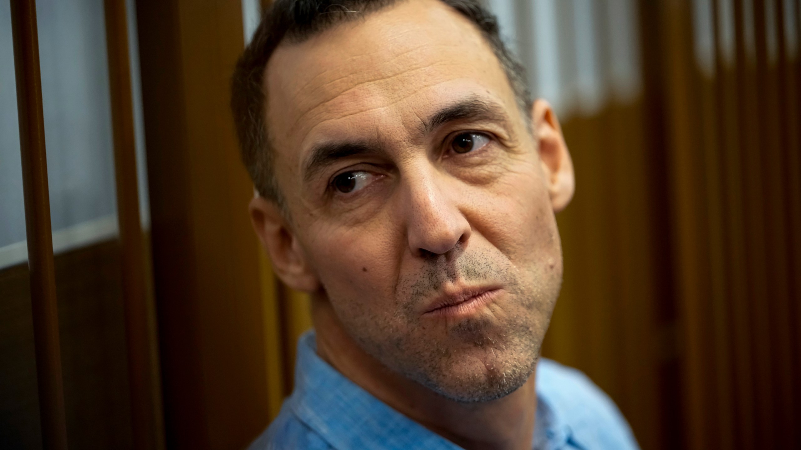 French citizen Laurent Vinatier sits in a cage prior to a court session at the Zamoskvoretsky District Court in Moscow, Russia, on Monday, Oct. 14, 2024. (AP Photo/Pavel Bednyakov)