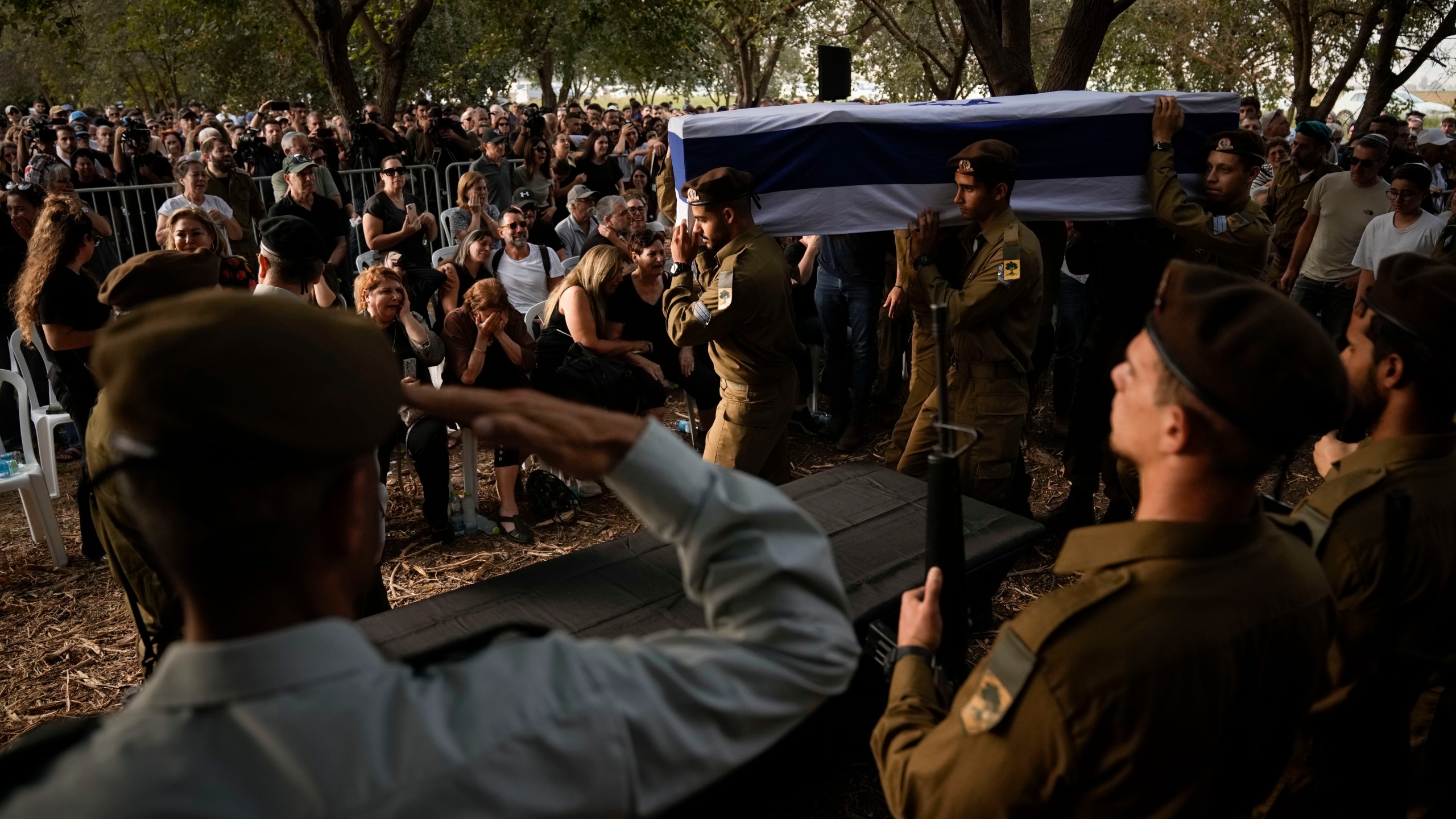 Israeli soldiers carry the flagged-covered coffin of Sgt. Amitai Alon, killed by a Hezbollah drone attack, during his funeral near Ramot Naftali, Israel, Monday, Oct. 14, 2024. (AP Photo/Leo Correa)