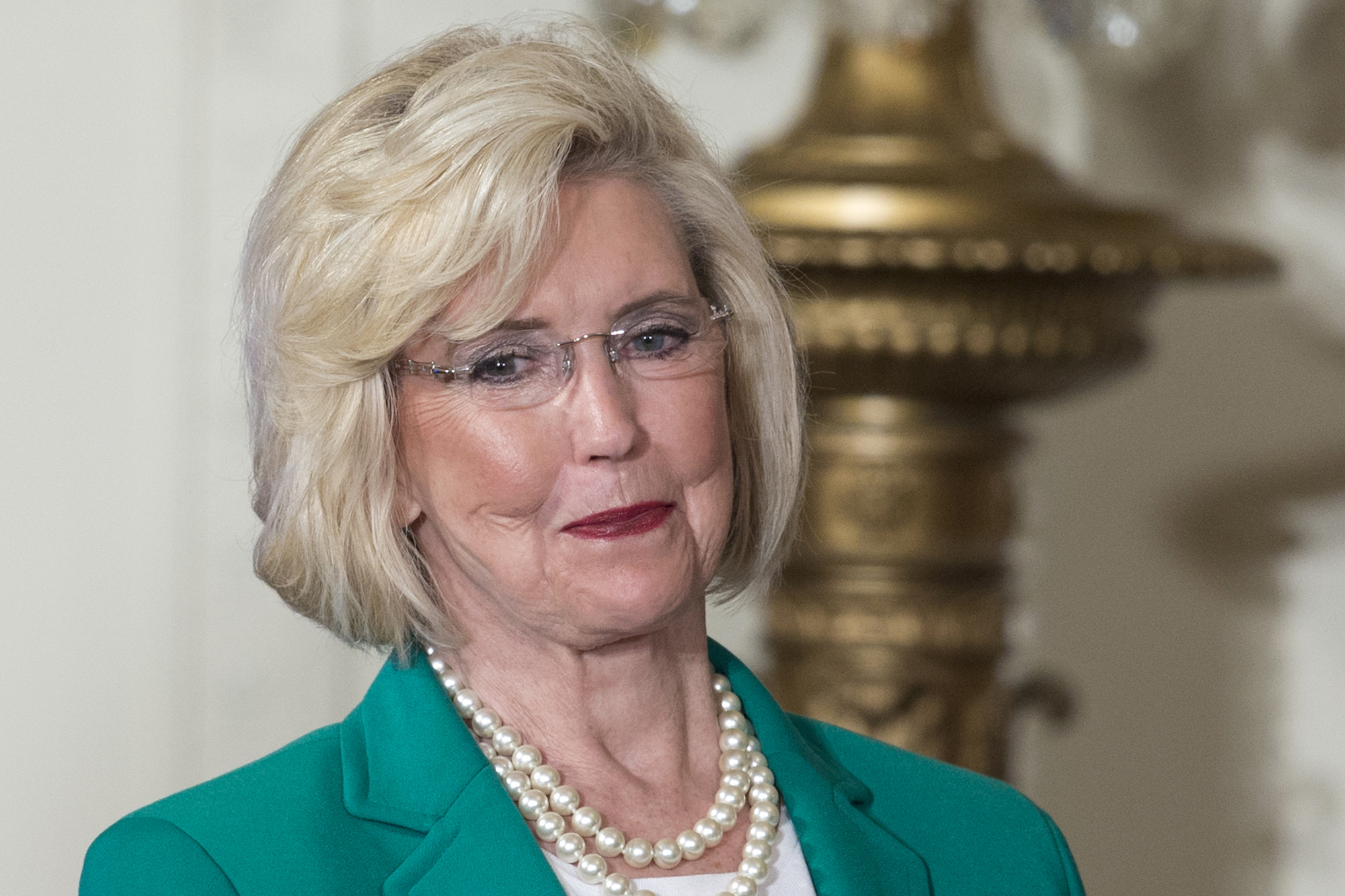 FILE - Lilly Ledbetter looks to the audience as President Barack Obama speaks in the East Room of the White House in Washington, April 8, 2014, during an event marking Equal Pay Day. (AP Photo/Carolyn Kaster, File)