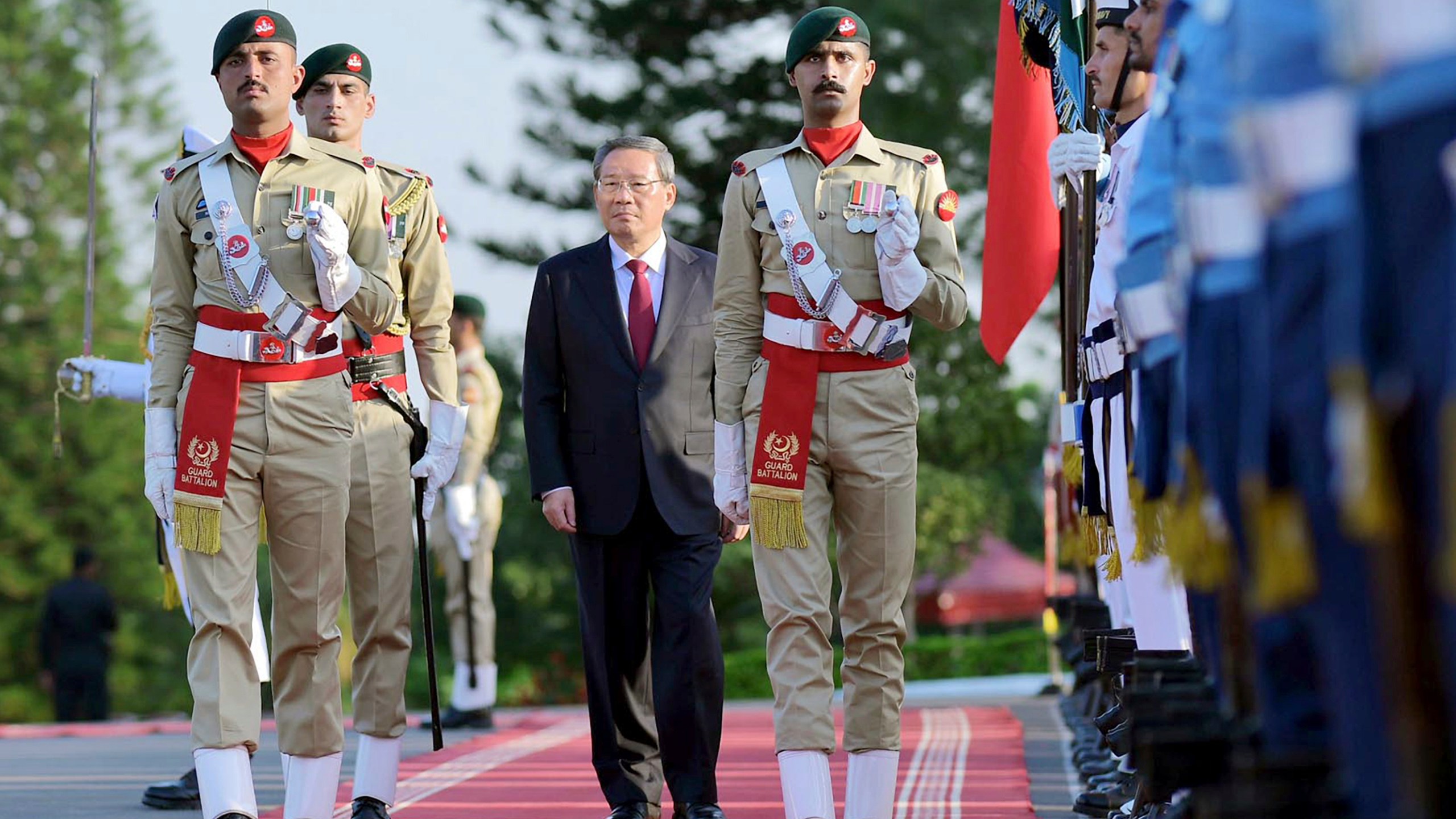 In this photo released by the Press Information Department, visiting China's Premier Li Qiang reviews the guard of honor during a welcome ceremony, in Islamabad, Pakistan, Monday, Oct. 14, 2024. (Press Information Department via AP)