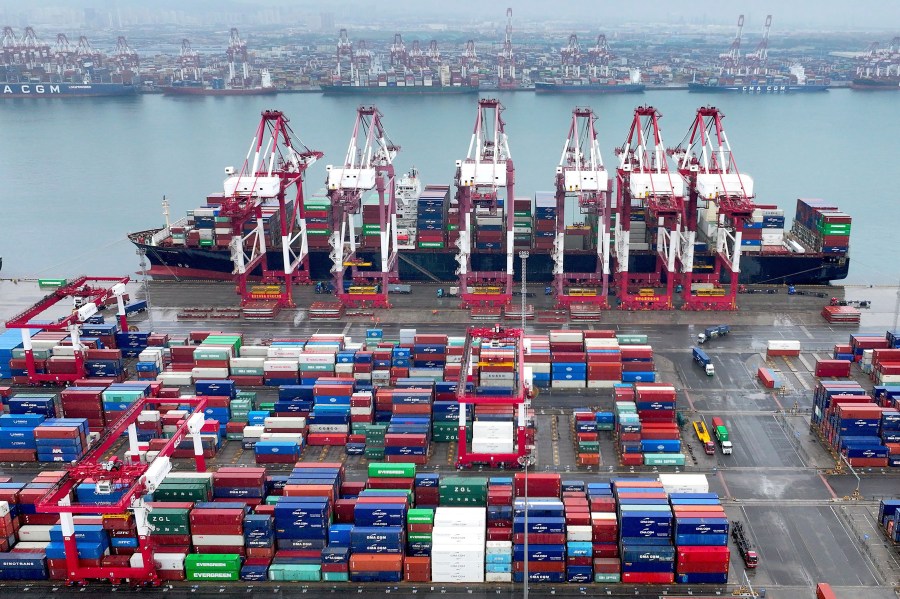 FILE - Cranes and transporters work at an automated container port in Qingdao in eastern China's Shandong province on July 7, 2024. (Chinatopix Via AP, File)