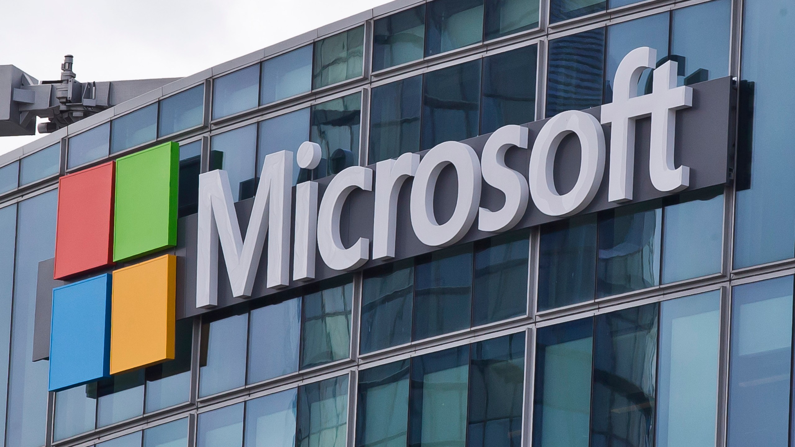 FILE - This April 12, 2016, file photo shows the Microsoft logo in Issy-les-Moulineaux, outside Paris, France. Russia, China and Iran are expanding their partnerships with cyber criminals to conduct cyberespionage and cyberattacks against the U.S. and other nations, according to a new report from Microsoft. Analysts at the tech giant say partnerships between authoritarian governments and criminal networks have benefits for both sides, increasing the volume and effectiveness of the cyber operations while giving criminals new avenues to profit and protection from prosecution. (AP Photo/Michel Euler, File)