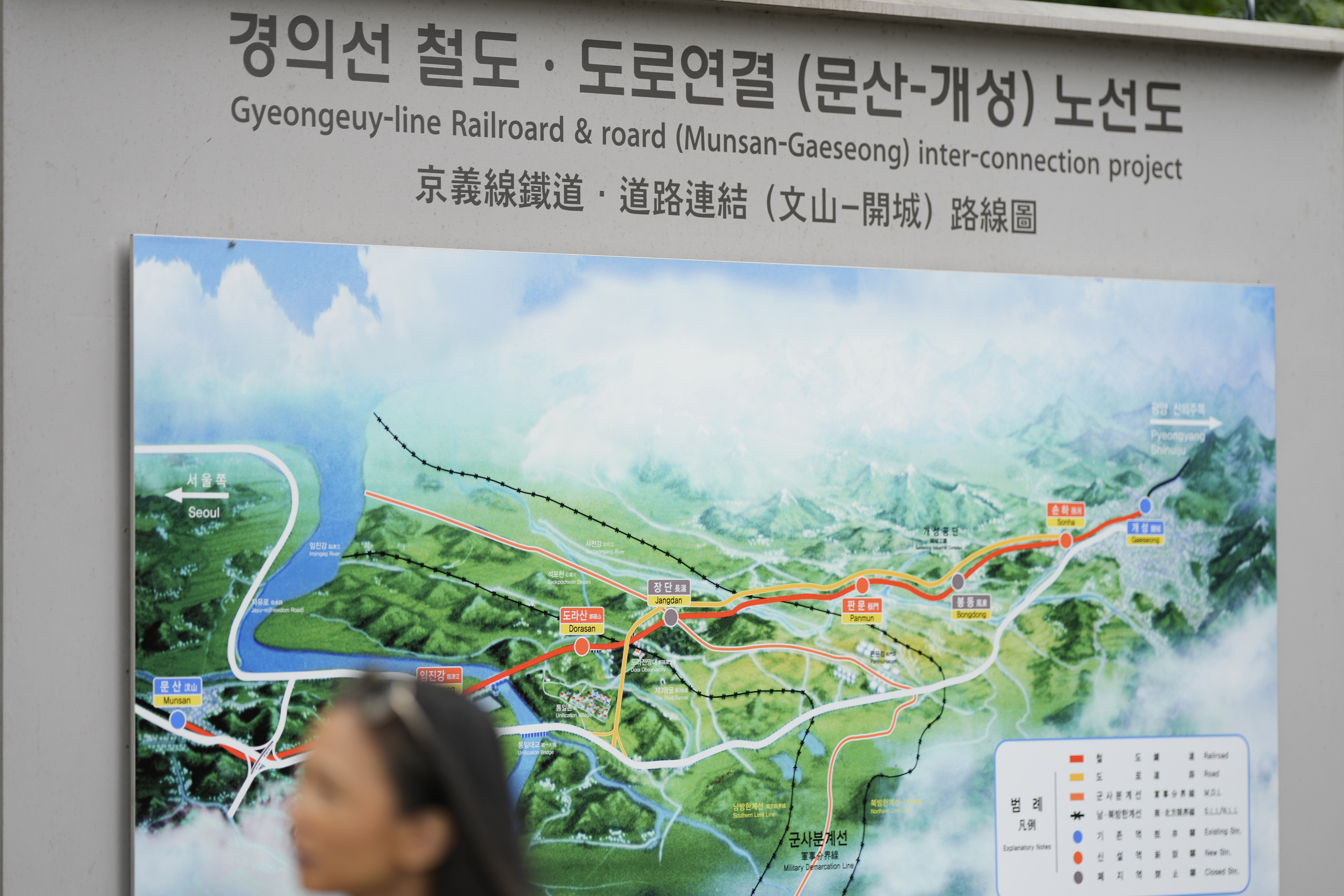 A visitor walks by a map of railroad and road between two Koreas cities, South's Munsan and North's Kaesong, at the Imjingak Pavilion in Paju, South Korea, Tuesday, Oct. 15, 2024. (AP Photo/Lee Jin-man)