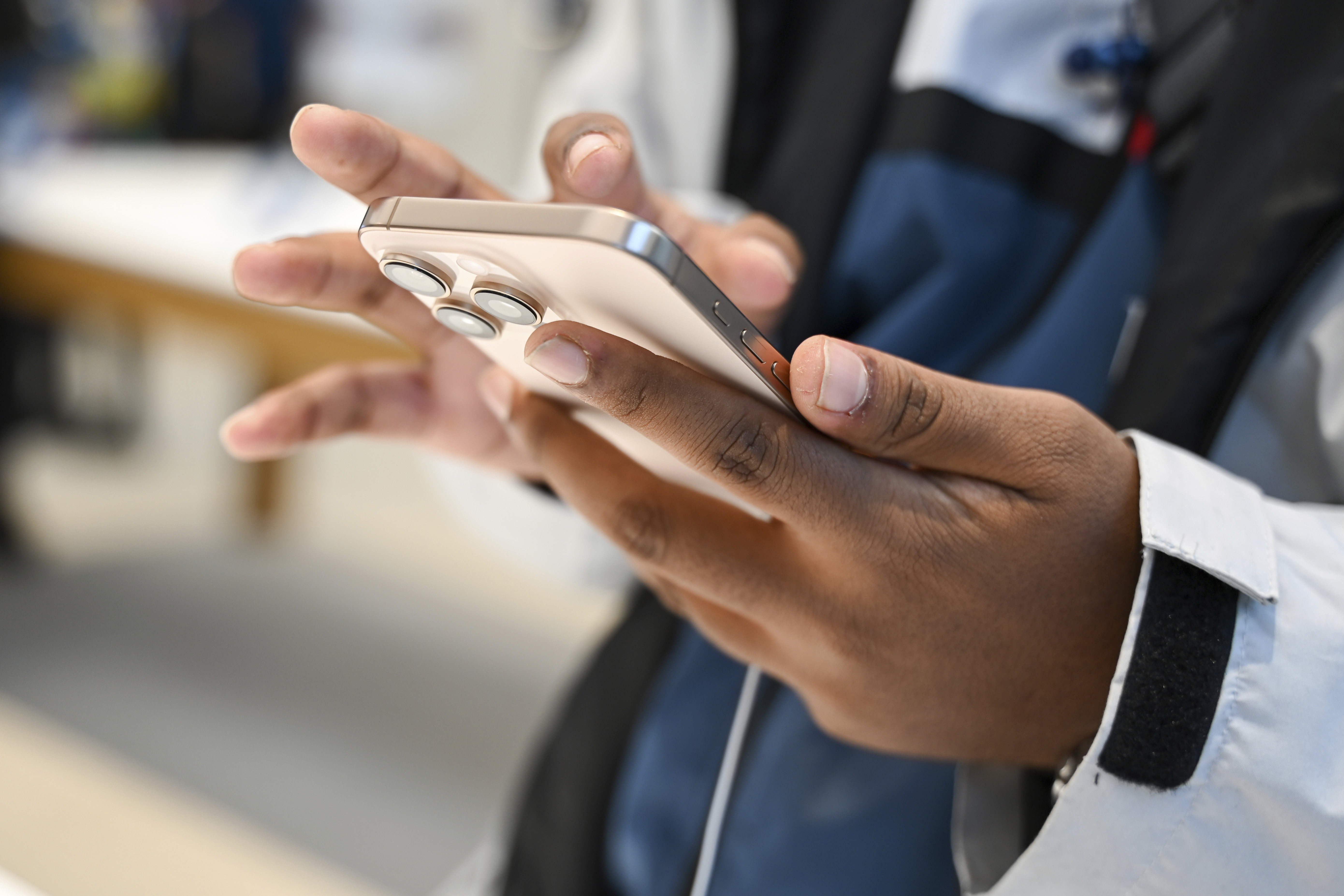 A man looks at the new iPhone 16 in the Apple store as the iPhone 16 with artificial intelligence software, and other Apple Watch products, go on sale, in Berlin, Friday, Sept. 20, 2024. (Katharina Kausche/dpa via AP)