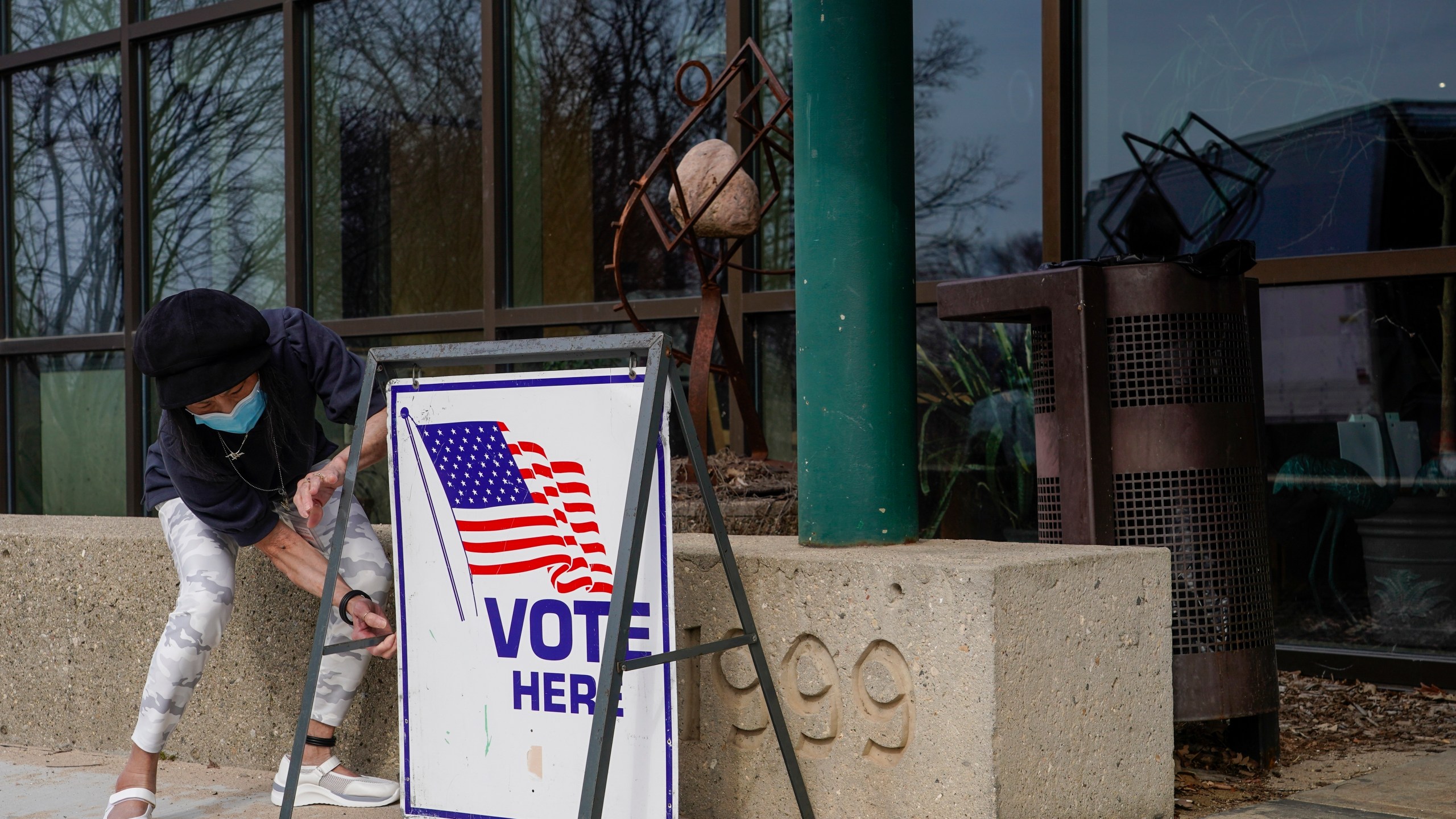 FILE- Poll worker Pranee Sheskey puts up a sign outside the Warner Park Community Recreation Center for the first day of early voting Tuesday, March 21, 2023, in Madison, Wis. (AP Photo/Morry Gash, File)