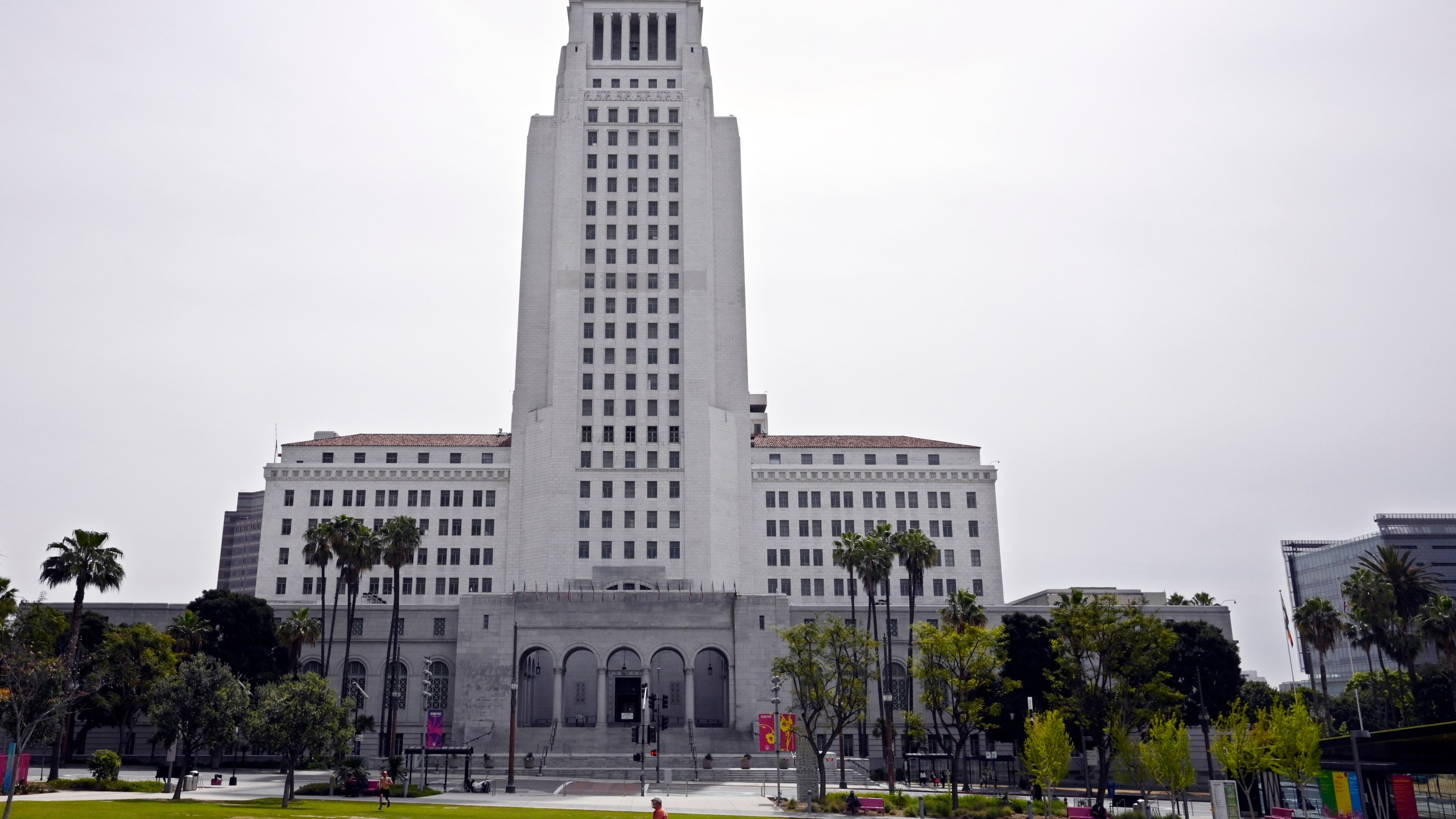 FILE - A few people use Grand Park at the foot of Los Angeles City Hall, Tuesday, March 31, 2020, in Los Angeles. (AP Photo/Mark J. Terrill, File)