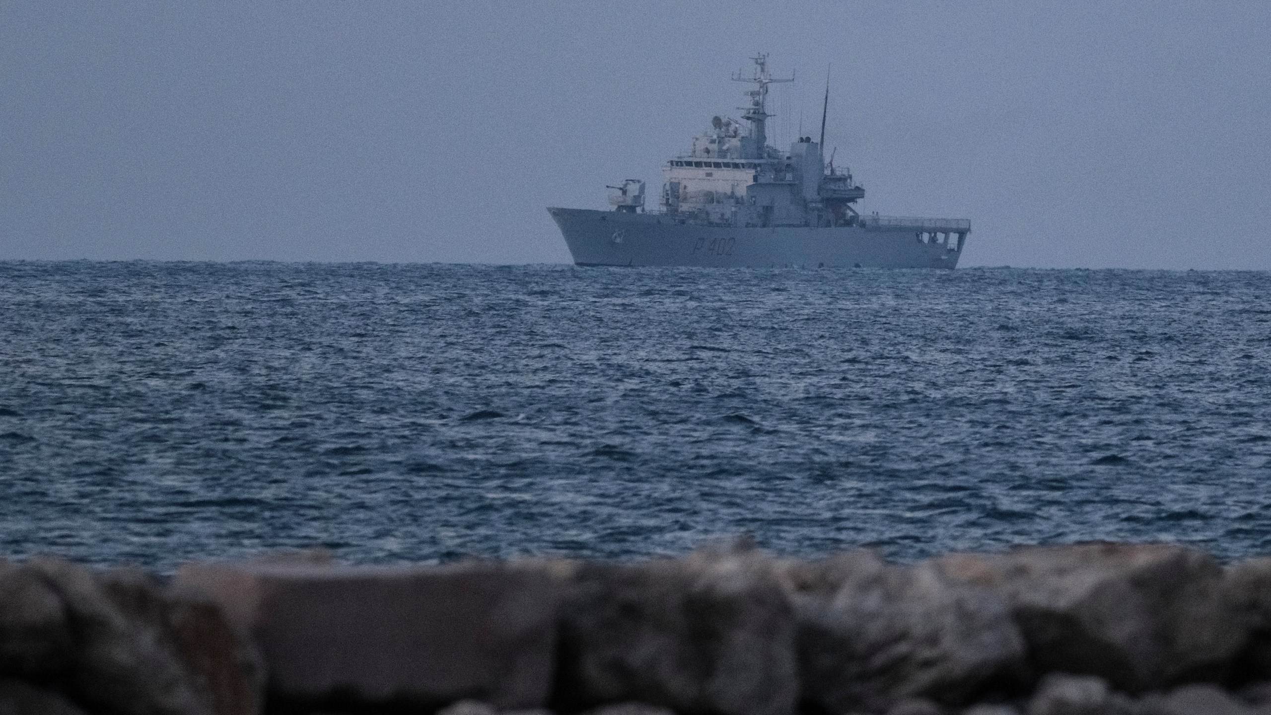 An Italian navy ship approaches the port of Shengjin northwestern Albania Wednesday, Oct. 16, 2024 carrying the first group of migrants who were intercepted in international waters and whose asylum applications will be processed in Albania instead of in Italy, under a five-year agreement between the two countries. (AP Photo/Vlasov Sulaj)