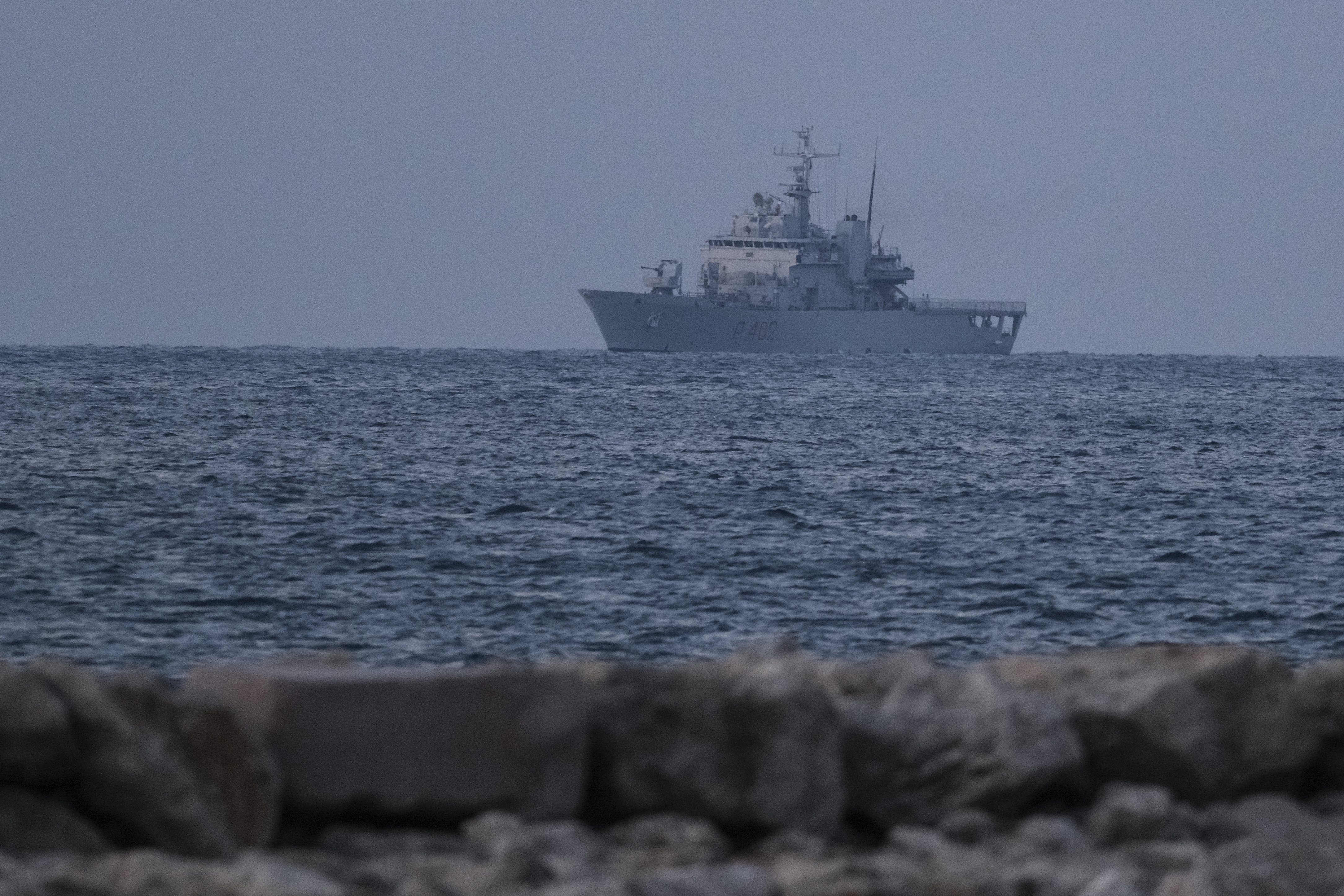 An Italian navy ship approaches the port of Shengjin northwestern Albania Wednesday, Oct. 16, 2024 carrying the first group of migrants who were intercepted in international waters and whose asylum applications will be processed in Albania instead of in Italy, under a five-year agreement between the two countries. (AP Photo/Vlasov Sulaj)