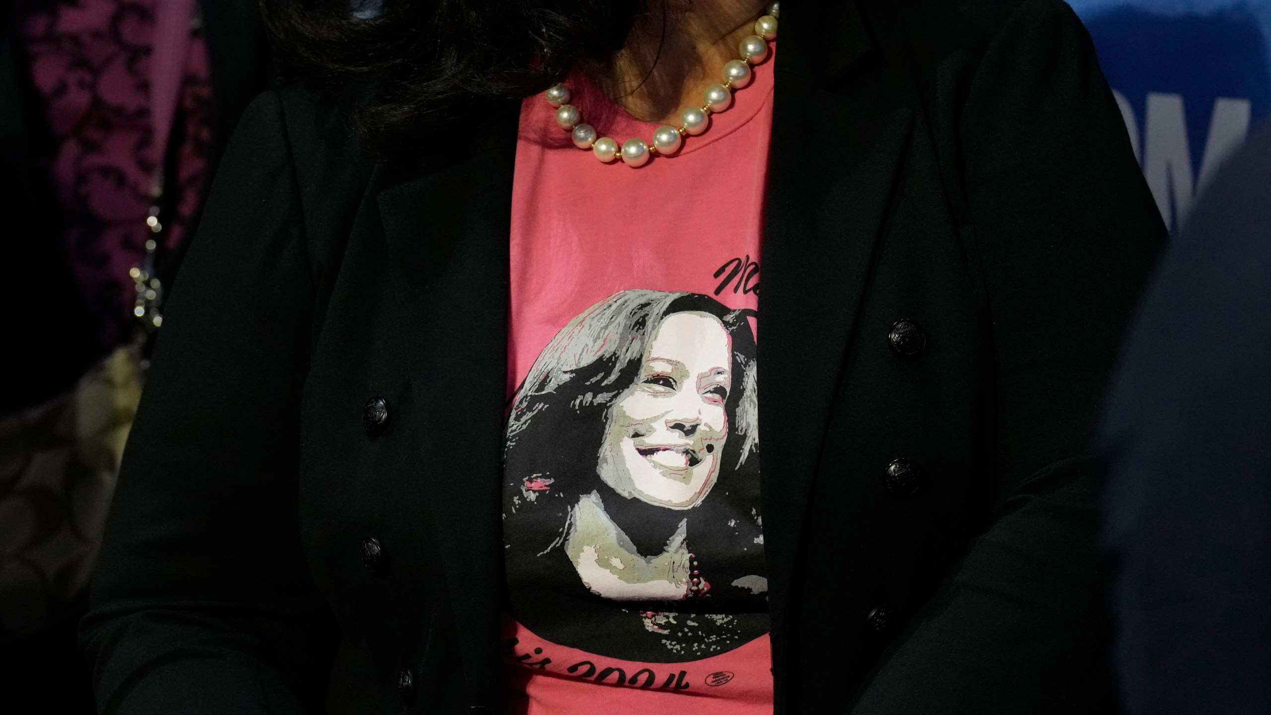 A supporter wearing a campaign-themed shirt sits in the audience at a campaign rally for Democratic presidential nominee Vice President Kamala Harris at Erie Insurance Arena, in Erie, Pa., Monday, Oct. 14, 2024. (AP Photo/Jacquelyn Martin)