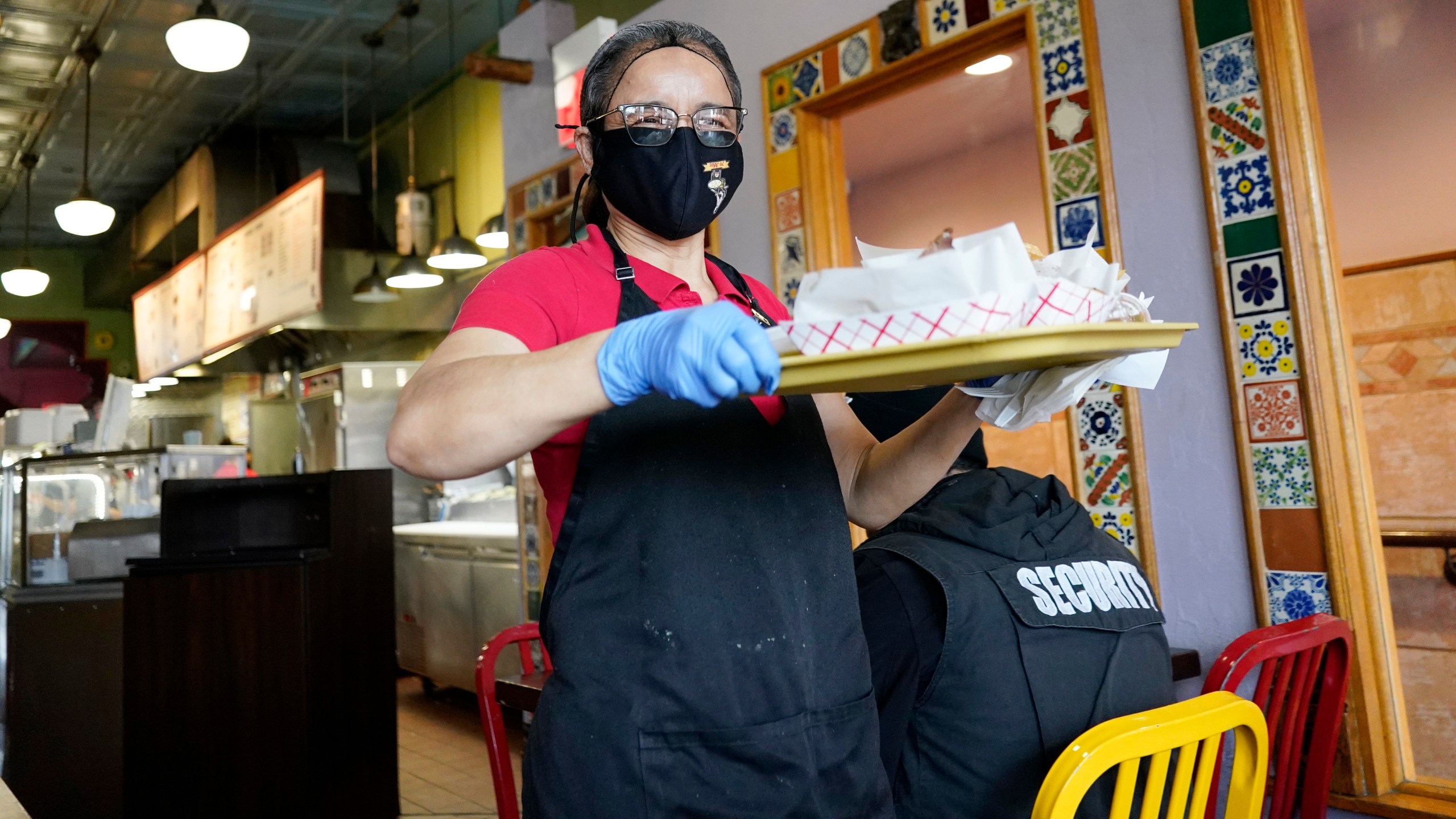 File - A waitress works at a restaurant in Chicago on March 23, 2023. (AP Photo/Nam Y. Huh, File)