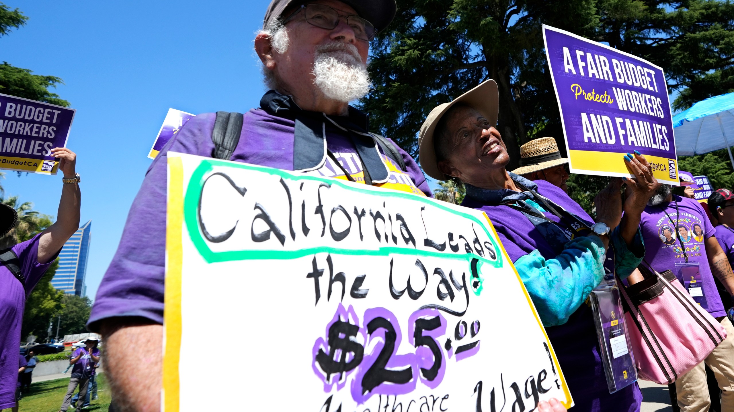 FILE - Retirees Ron Martin, left, and Willie Mae Hampton, right, join other supporters of the Service Employees International Union at a rally against proposed budget cuts to state provided social safety net programs, in Sacramento, Calif., Tuesday, June 11, 2024. (AP Photo/Rich Pedroncelli, File)